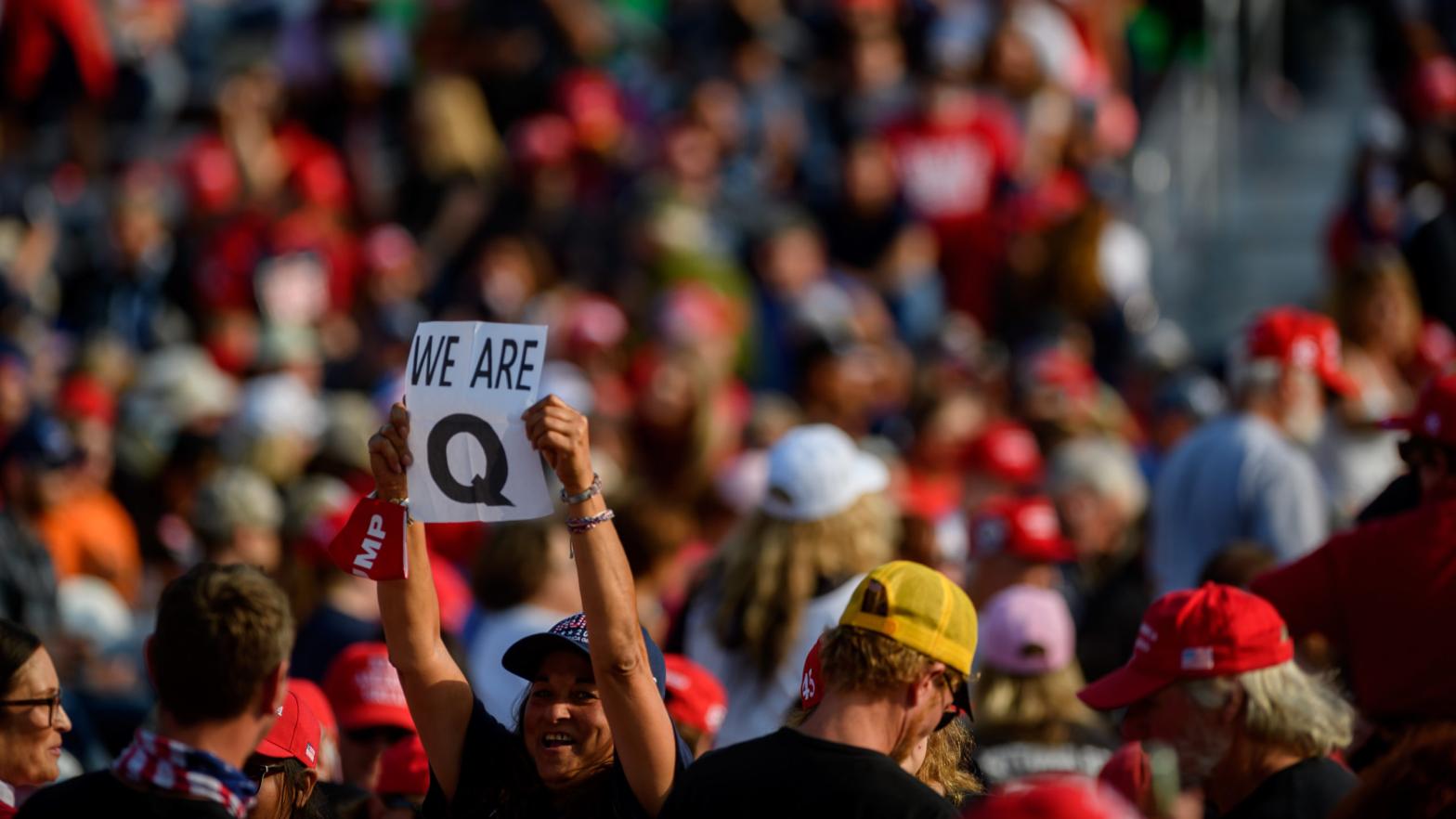 A woman holds up a QAnon sign to the media as attendees wait for President Donald Trump to speak at a campaign rally at Atlantic Aviation on September 22, 2020 in Moon Township, Pennsylvania.  (Photo: Jeff Swensen, Getty Images)