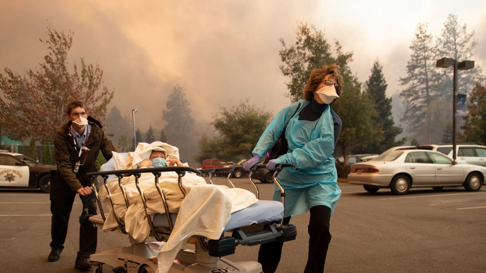 Patients are quickly evacuated from the Feather River Hospital as it burns down during the Camp fire in Paradise, California on Nov. 8, 2018. (Photo: Josh Edelson/AFP, Getty Images)