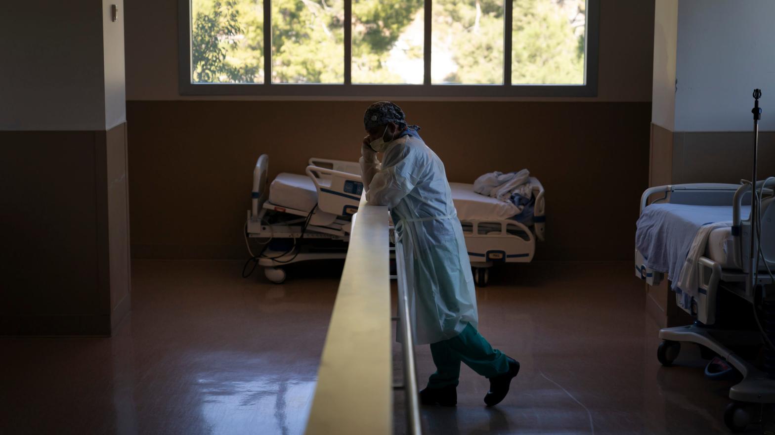 Respiratory therapist Babu Paramban talks on the phone next to hospital beds while taking a break in the COVID-19 unit at Providence Holy Cross Medical Centre in the Mission Hills section of Los Angeles, Thursday, Nov. 19, 2020. (Photo: Jae C. Hong, AP)