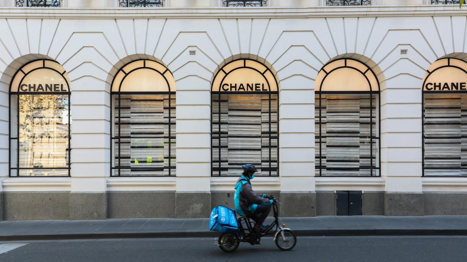 File photo of a food delivery rider driving past a Chanel store on October 26, 2020 in Melbourne, Australia. (Photo: Asanka Ratnayake, Getty Images)