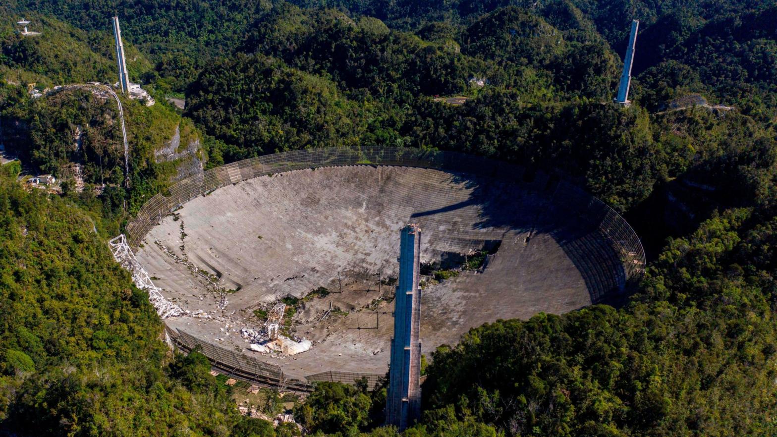 Aerial footage showing the damaged dish at the Arecibo Observatory and three support towers.  (Image: Ricardo Arduengo/AFP via Getty Images, Getty Images)