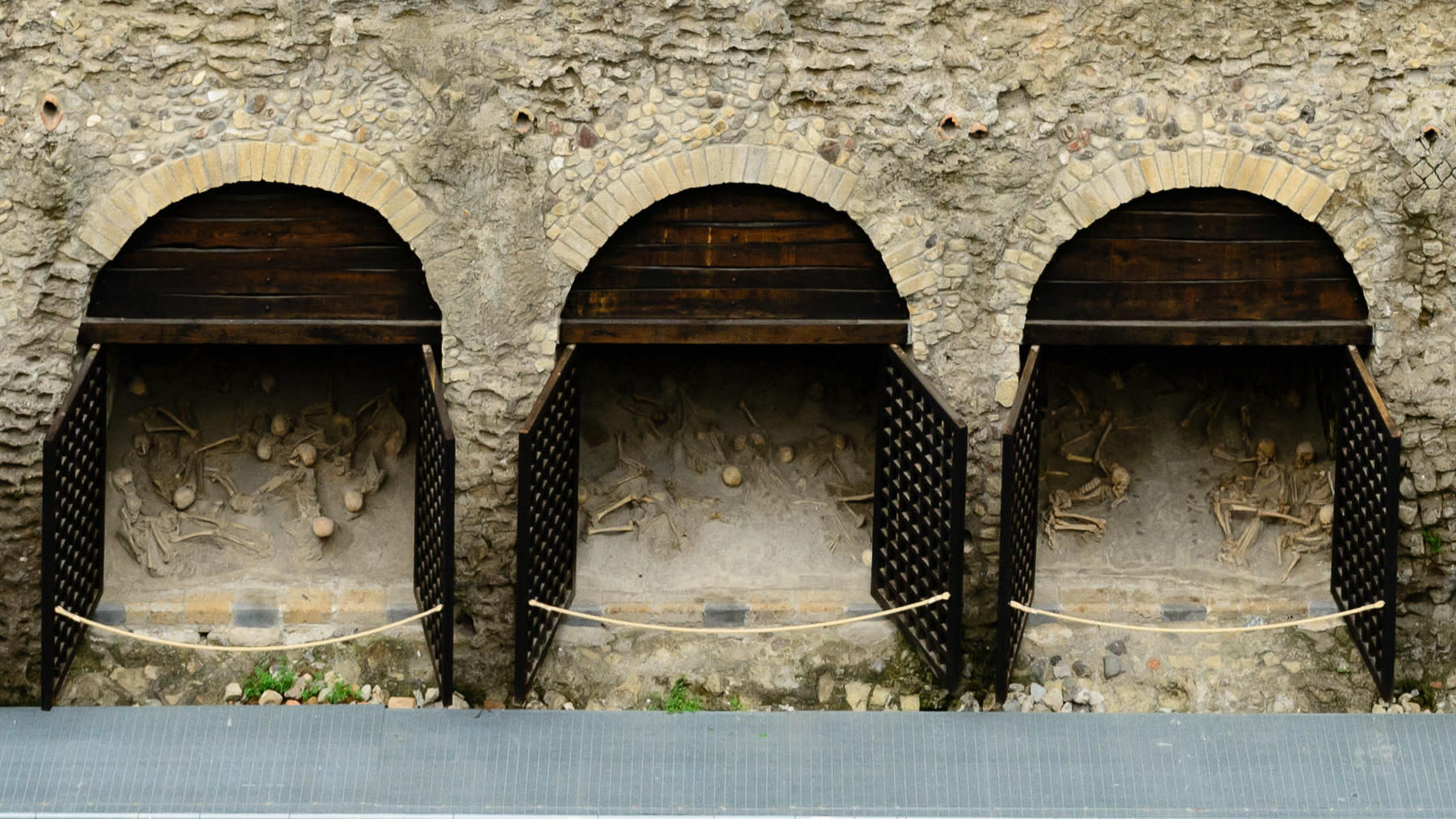 Three of 12 boat chambers at Herculaneum, with skeletons inside. (Image: Norbert Nagel)
