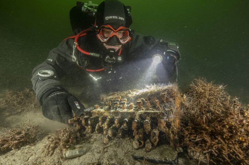 A diver inspecting the historic artefact.  (Image: Florian Huber)