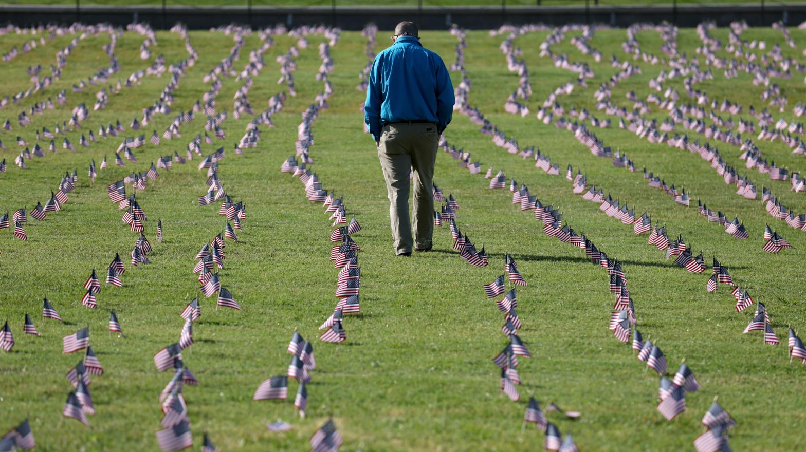 A man walking through a memorial at the National Mall in Washington, DC, created this September to commemorate the 200,000 American lives lost to the pandemic at the time. As many as 500,000 Americans may die before the pandemic ends, some experts have estimated.  (Photo: Win McNamee, Getty Images)