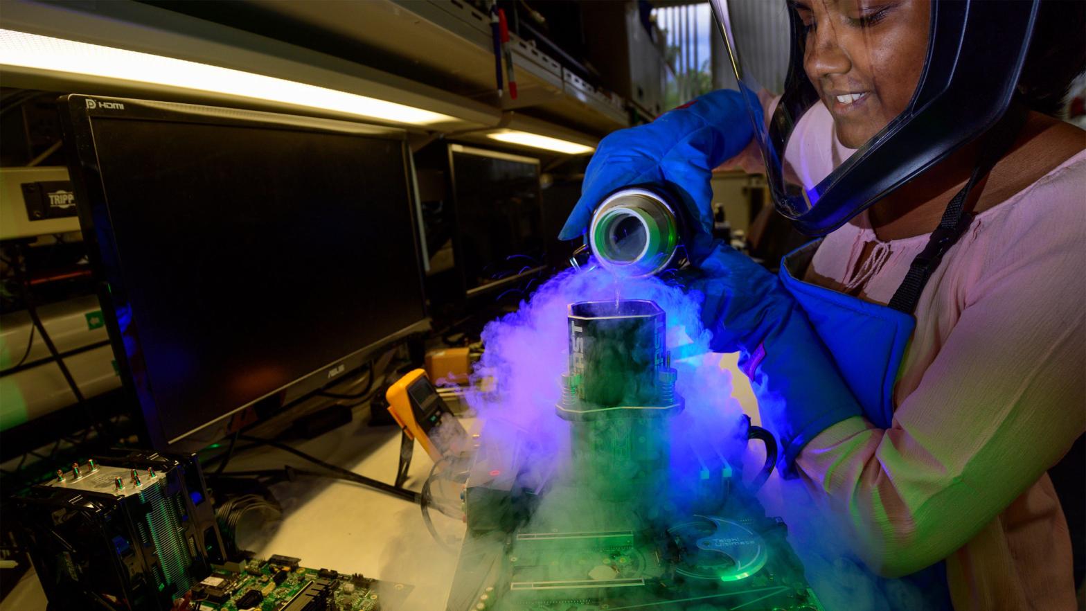 Navya Pramod, a systems engineer in Intel's overclocking lab in Hillsboro, Oregon, pours liquid nitrogen to cool down a 9th Gen Intel Core i9-9900K processor during an overclocking demonstration in September 2019. (Photo: Walden Kirsch/Intel Corporation)
