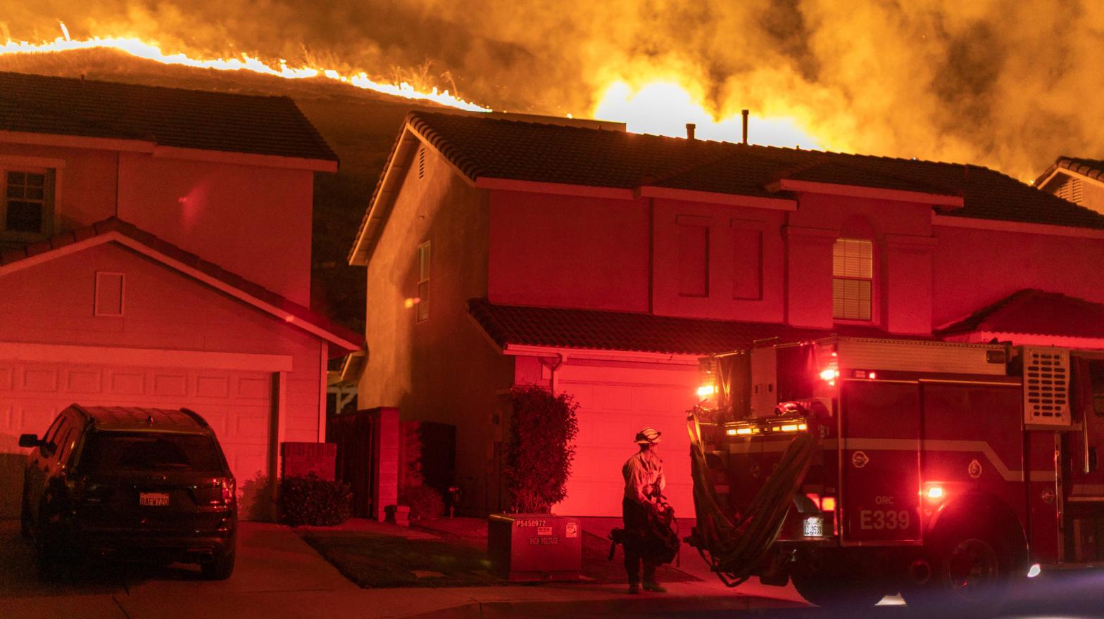 Flames come close to houses during the Blue Ridge Fire on Oct. 27, 2020 in Chino Hills, California.  (Photo: David McNew, Getty Images)