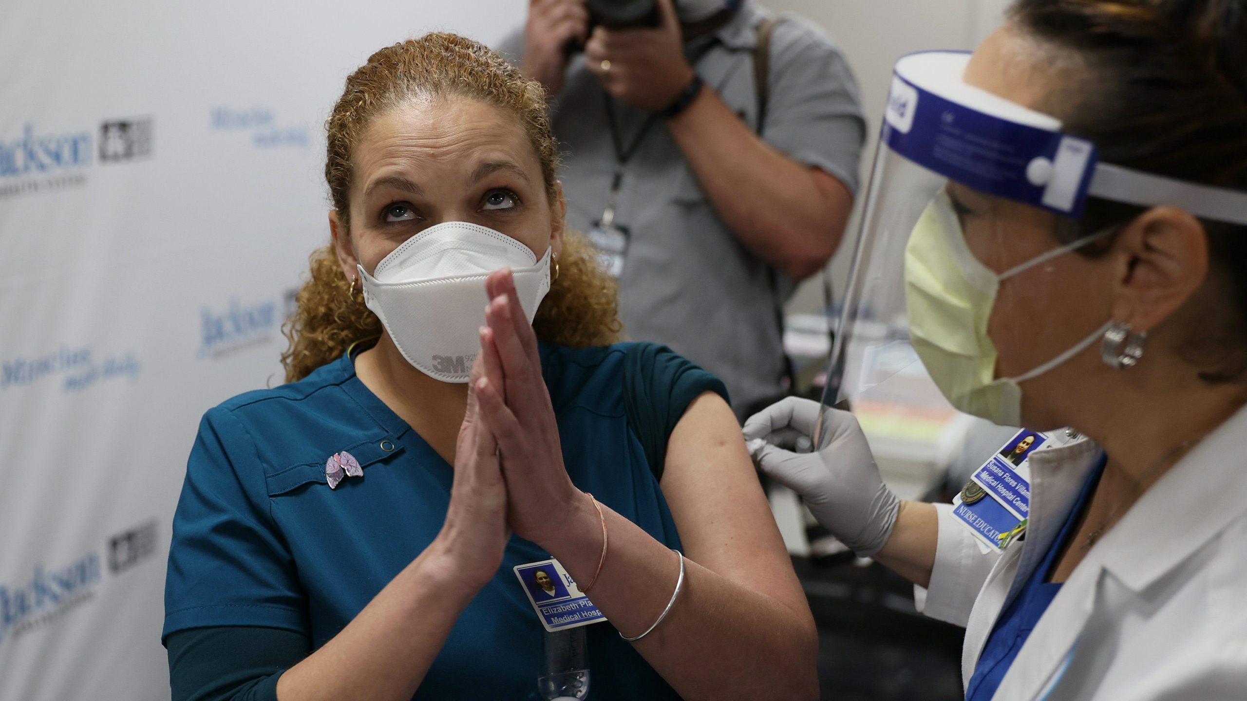 Elizabeth Plasencia, RRT Medical Hospital Centre at the Jackson Health Systems, clasps her hands together after receiving a Pfizer/BioNtech covid-19 vaccine from Susana Flores Villamil, RN from Jackson Health Systems, at the Jackson Memorial Hospital on December 15, 2020 in Miami, Florida.  (Photo: Joe Raedle, Getty Images)