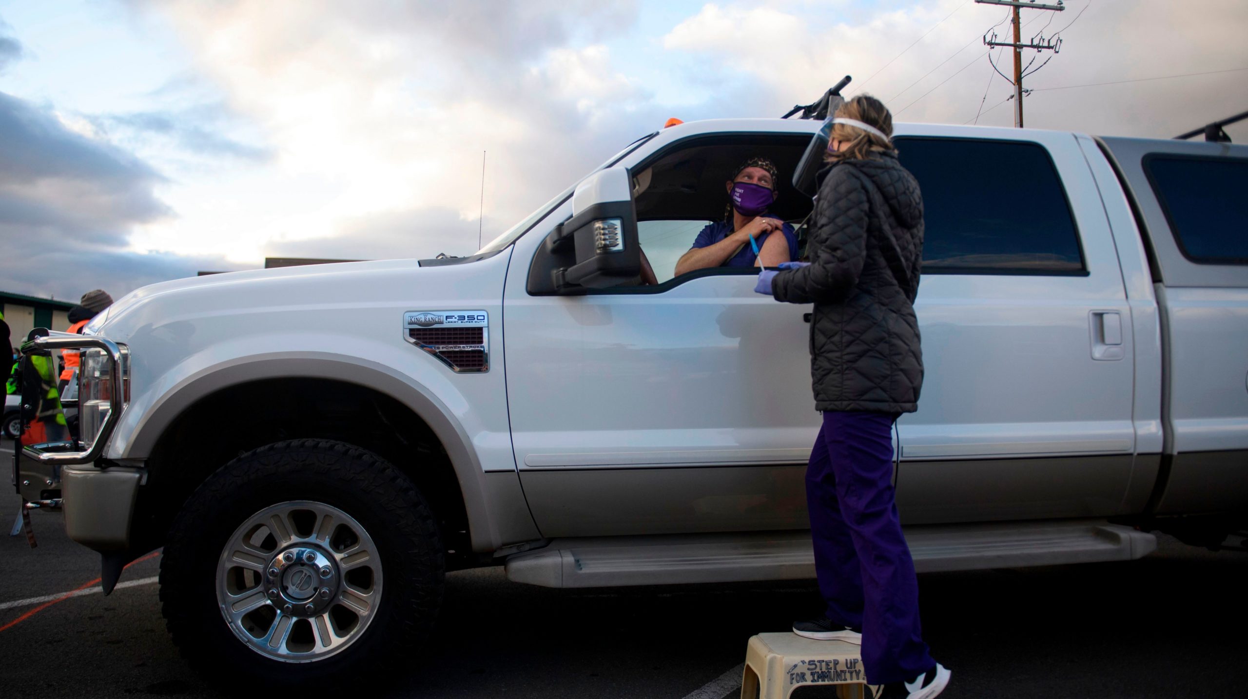 Dr. Bret Frey, an emergency medicine physician, talks with a nurse from inside a truck after receiving a first dose of the Pfizer/BioNTech covid-19 vaccine under an emergency use authorization at a drive-up vaccination site from Renown Health on December 17, 2020 in Reno, Nevada. (Photo: Patrick T. Fallon / AFP, Getty Images)