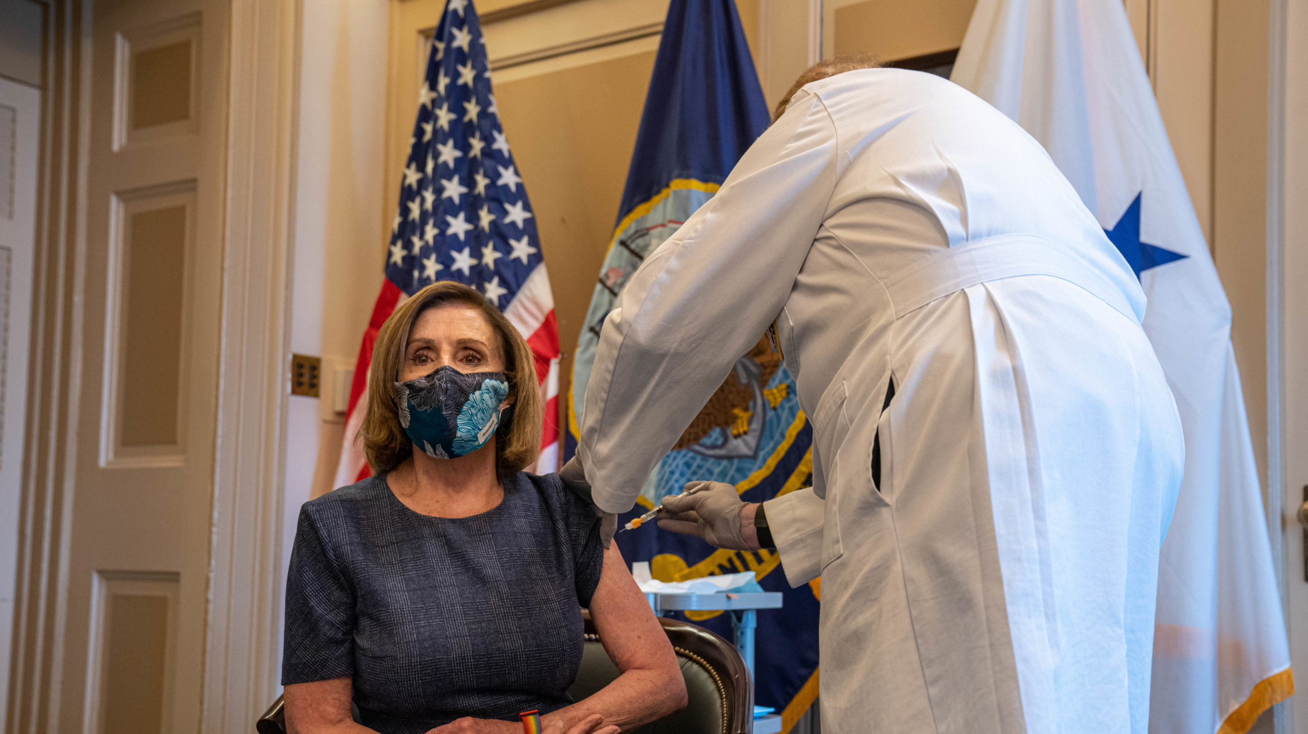 Speaker of the House Nancy Pelosi (D-CA) receives a covid-19 vaccination shot by doctor Brian Monahan, attending physician of the United States Congress, in her office in Washington, D.C., on December 18, 2020. (Photo: Ken Cedeno / various sources / AFP, Getty Images)