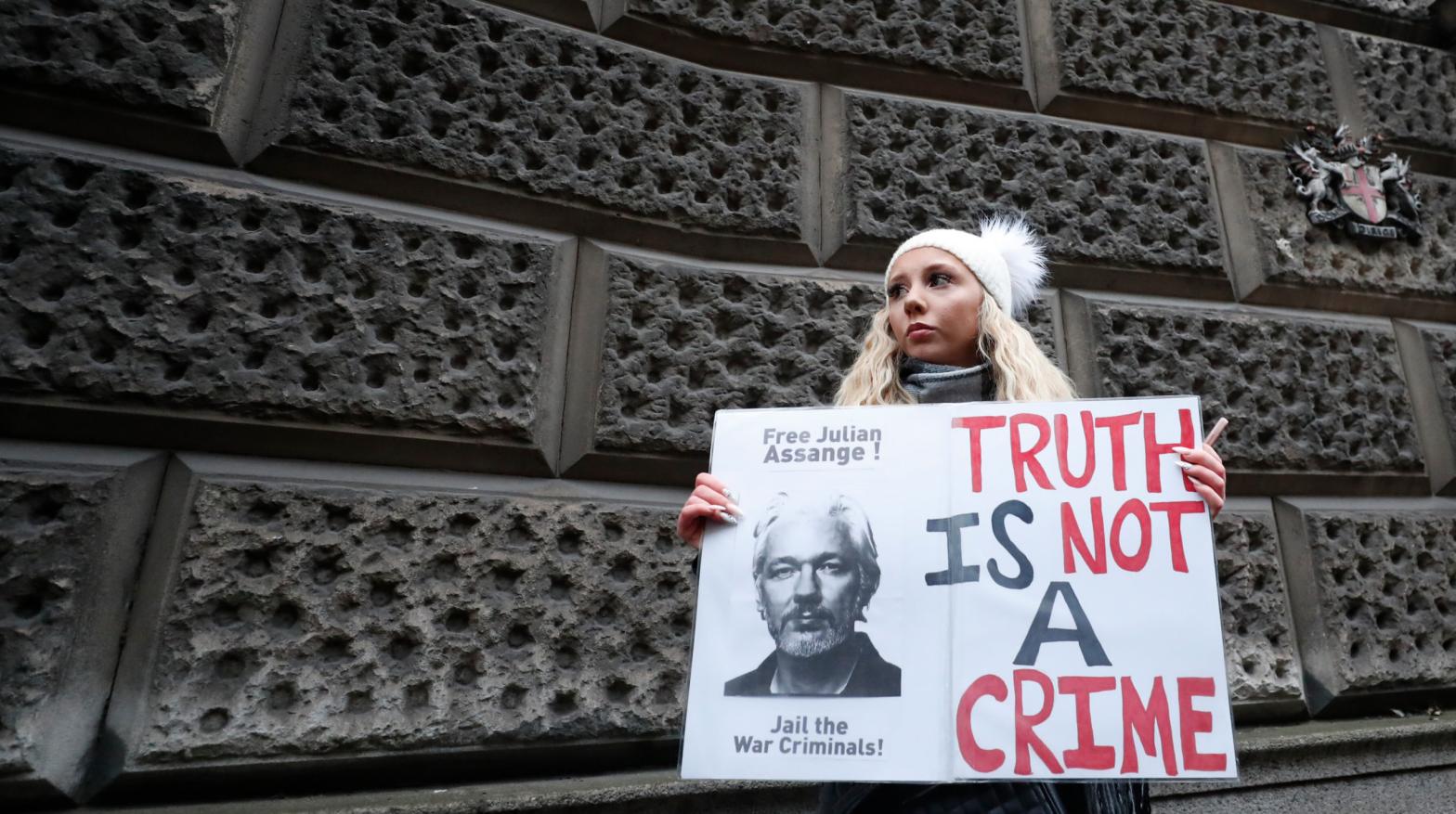 A Julian Assange supporter holds a placard with a message of support for him outside the Old Bailey in London, Monday, Jan. 4, 2021.  (Photo: Frank Augstein, AP)