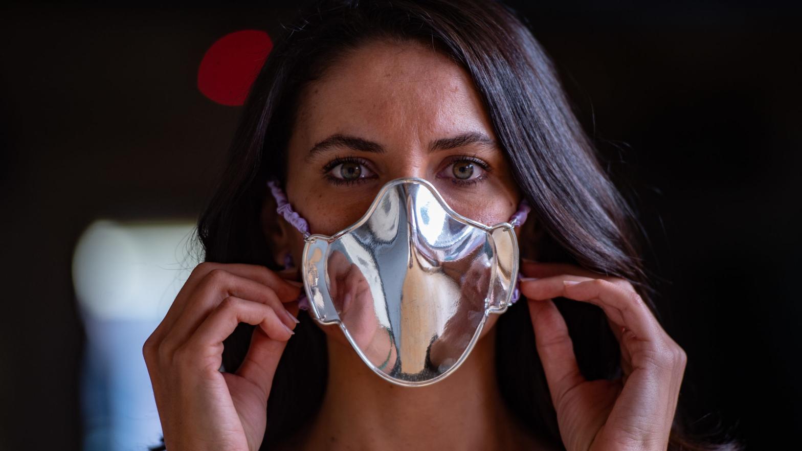 A woman tries a protective face mask made of silver and designed by Turkish silver master Sabri Demirci at his shop in Istanbul on December 22, 2020. (Photo: Yasin Akgul / AFP, Getty Images)