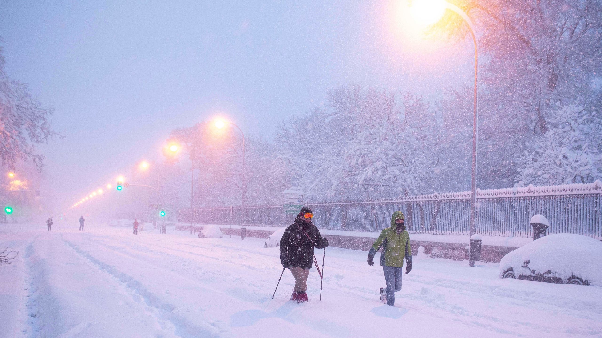 People walk amid a heavy snowfall in Madrid on January 9, 2021. (Photo: Benjamin Cremel/AFP, Getty Images)