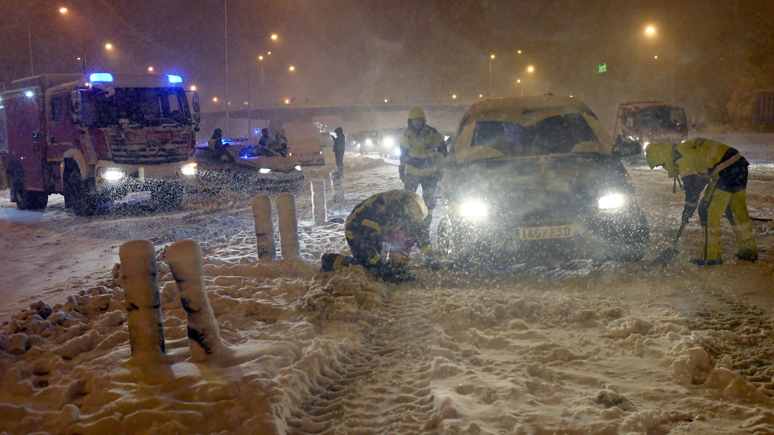 Firefighters help vehicles stuck in the M30 ring road in Madrid due to a heavy snowstorm on January 8, 2021.  (Photo: Oscar Del Pozo/AFP, Getty Images)