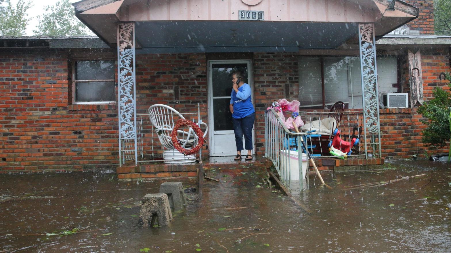 A woman on mobile phone calls for help at her flooded residence in Lumberton, North Carolina, on Sept. 15, 2018 in the wake of Hurricane Florence. (Photo: Alex Edelman/AFP, Getty Images)
