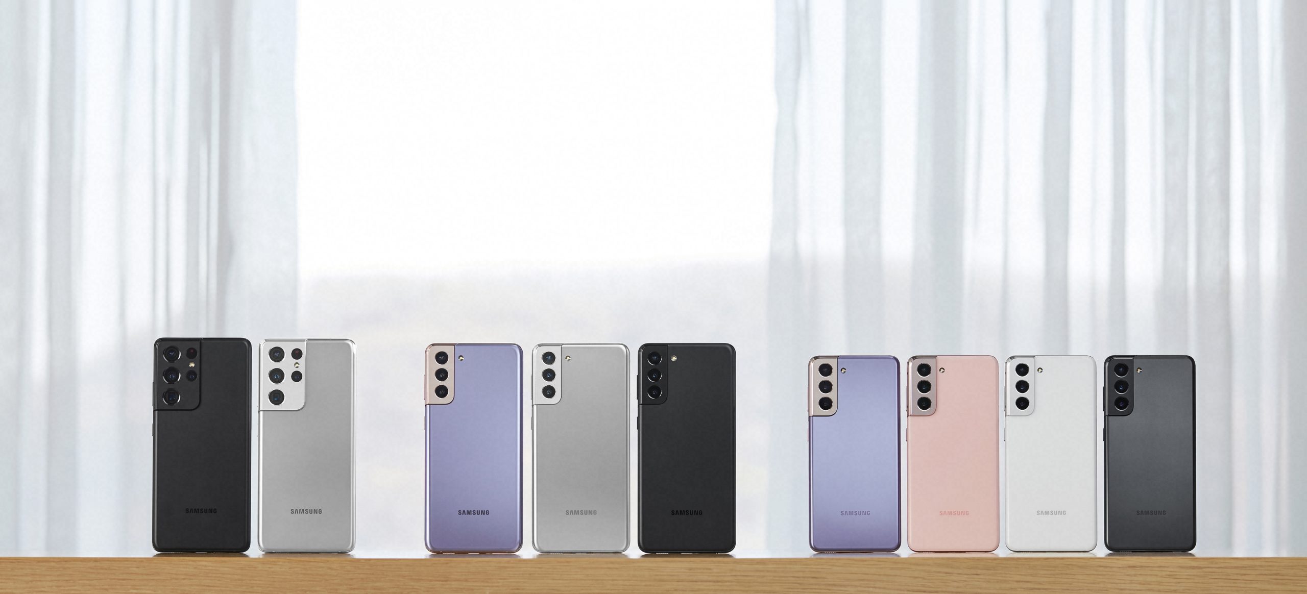 Here's the full S21 family from left to right: the S21 Ultra in black and silver, the S21+ in purple, silver, and black, and the standard S21 in purple, pink, silver, and black.  (Image: Samsung)