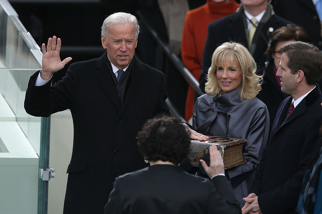 WASHINGTON, DC - JANUARY 21: U.S. Vice President Joe Biden is sworn in by Supreme Court Justice Sonia Sotomayor as wife Dr. Jill Biden and son Beau Biden look on during the presidential inauguration on the West Front of the U.S. Capitol January 21, 2013 in Washington, DC. Barack Obama was re-elected for a second term as President of the United States.