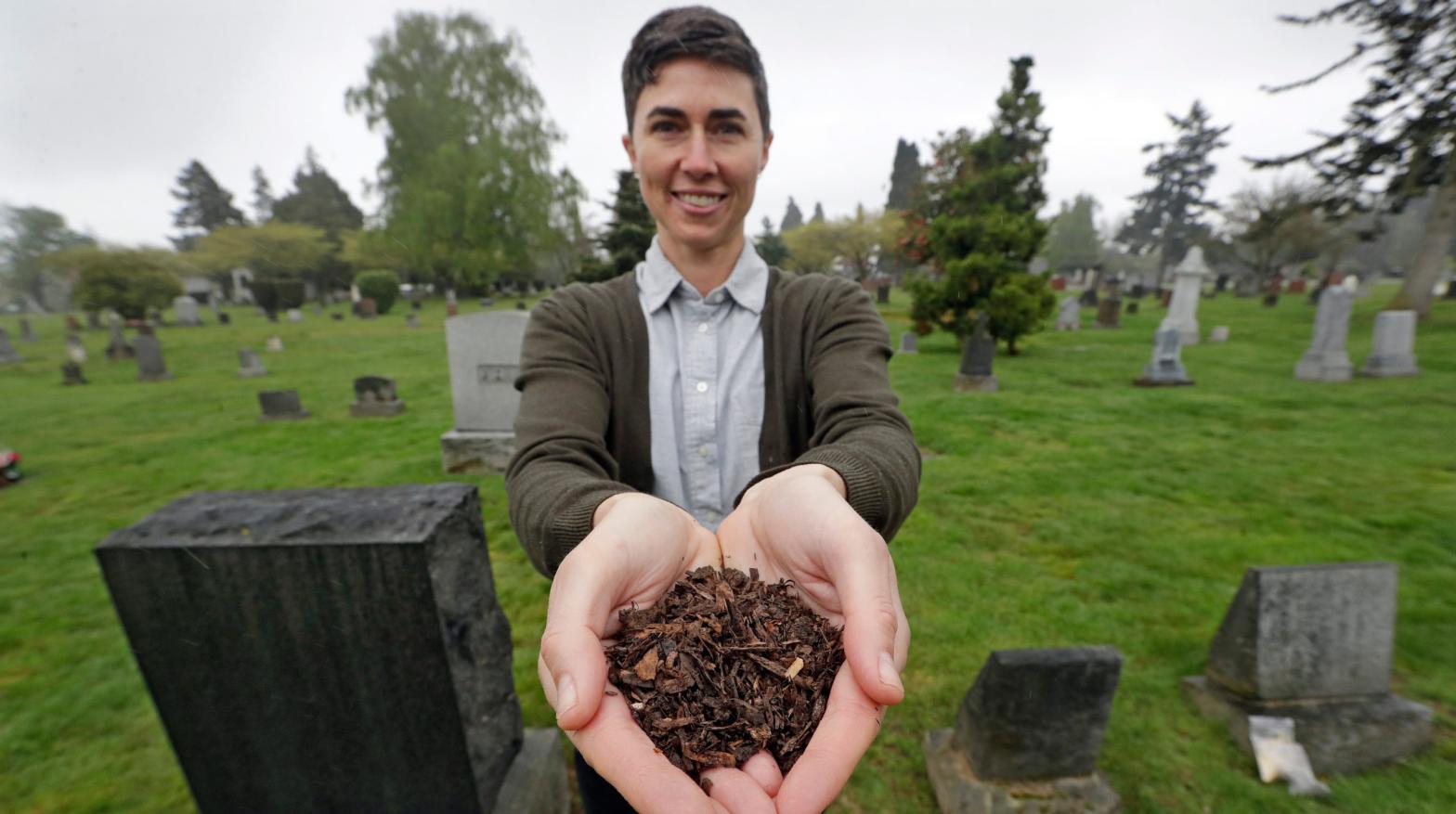 Katrina Spade, the founder and CEO of Recompose, showing off the wood shavings and other plant mulch used to help bodies compost in a photo taken in April 2019 (Photo: Elaine Thompson, AP)