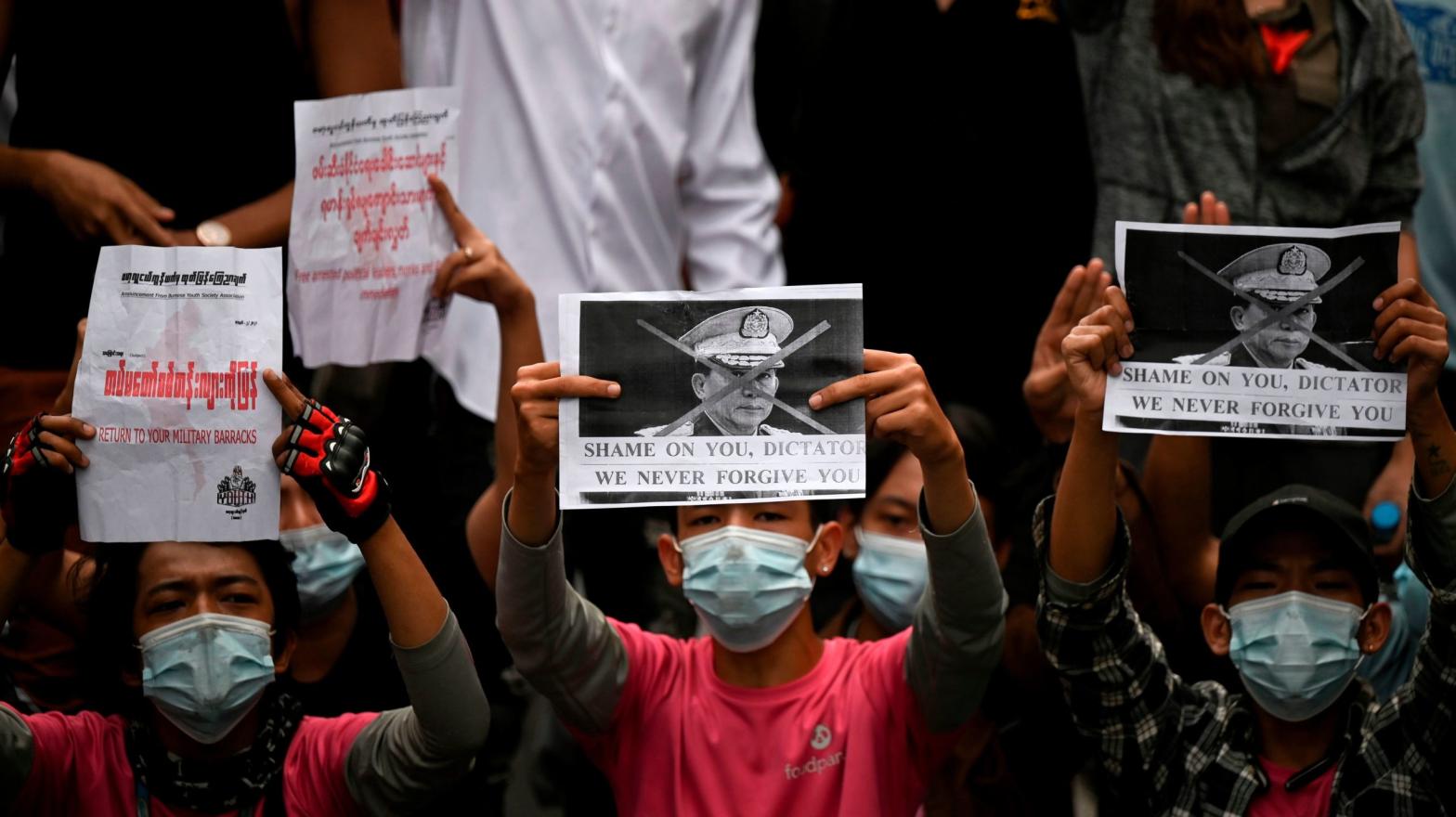 Protesters hold placards during a demonstration against the military coup in Yangon on February 6, 2021.  (Photo: Ye Aung Thu / AFP, Getty Images)