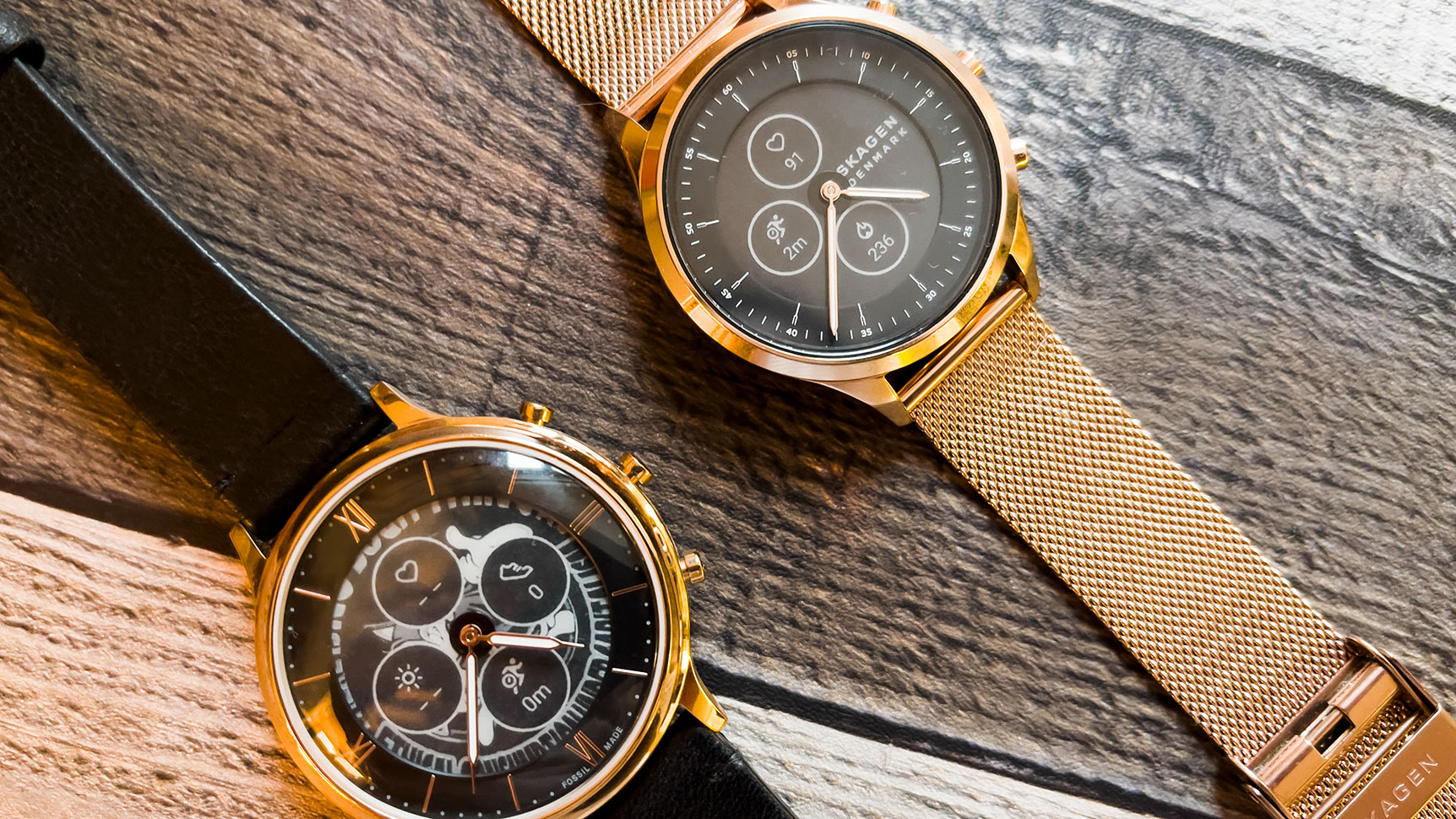 The Fossil Hybrid HR (left) and the Skagen Jorn. Both are pretty, but I prefer the Jorn's more subtle design. (Photo: Victoria Song/Gizmodo)