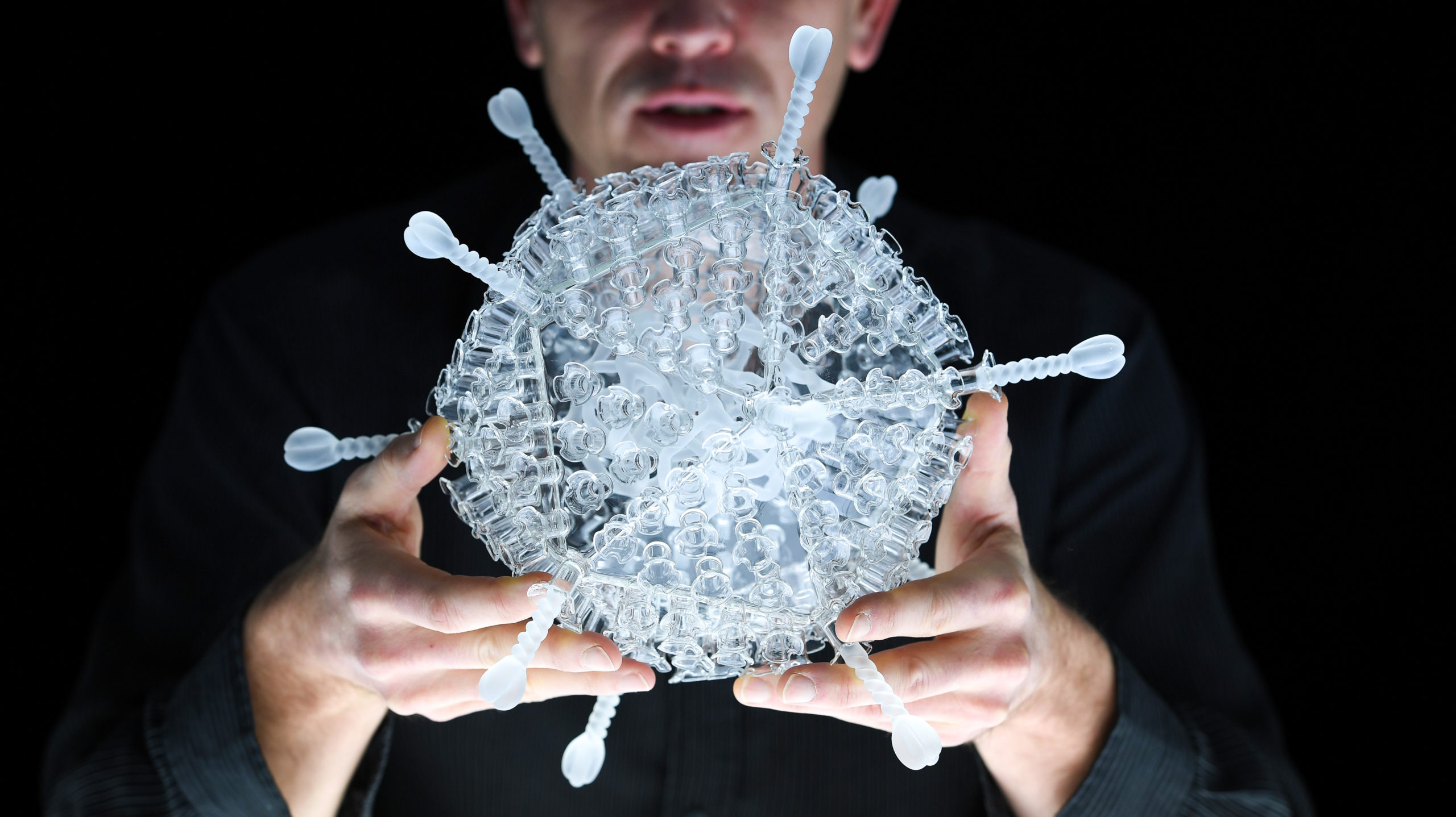 Artist Luke Jerram with his glass sculpture of the Oxford-AstraZeneca coronavirus vaccine at the Paintworks on February 05, 2021 in Bristol, England. (Photo: Finnbarr Webster, Getty Images)