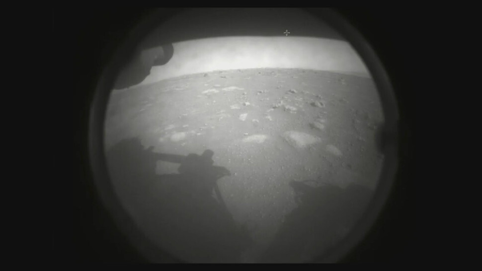 The first image sent back by Perseverance, taken using its hazard camera. (Image: NASA)