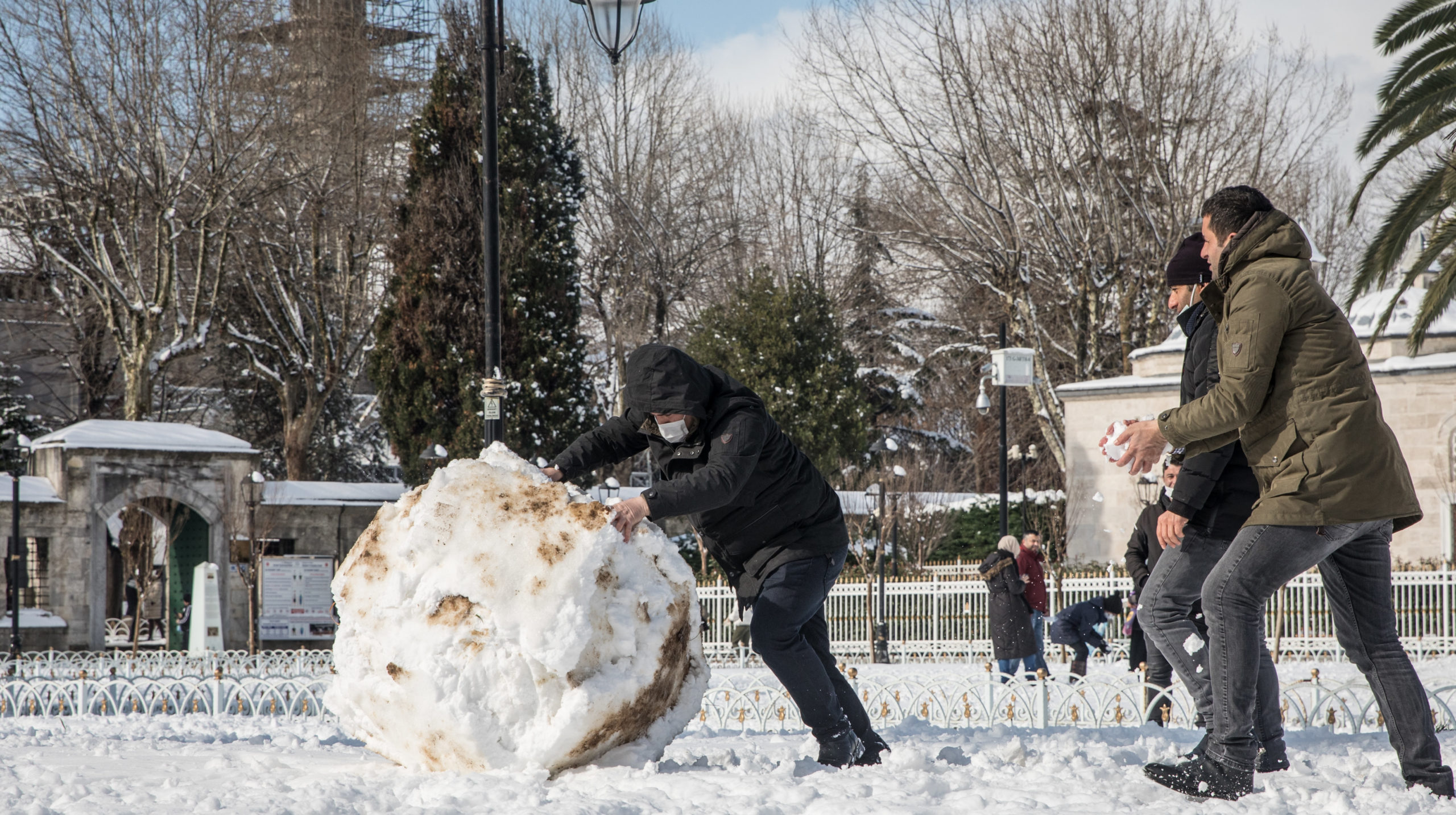 A man pushes a large snowball in front of the Blue Mosque on February 17, 2021 in Istanbul, Turkey. An overnight cold front brought heavy snowfall to Istanbul in the early morning, covering the city in snow, delaying morning commutes, and disrupting ferry services. (Photo: Chris McGrath, Getty Images)