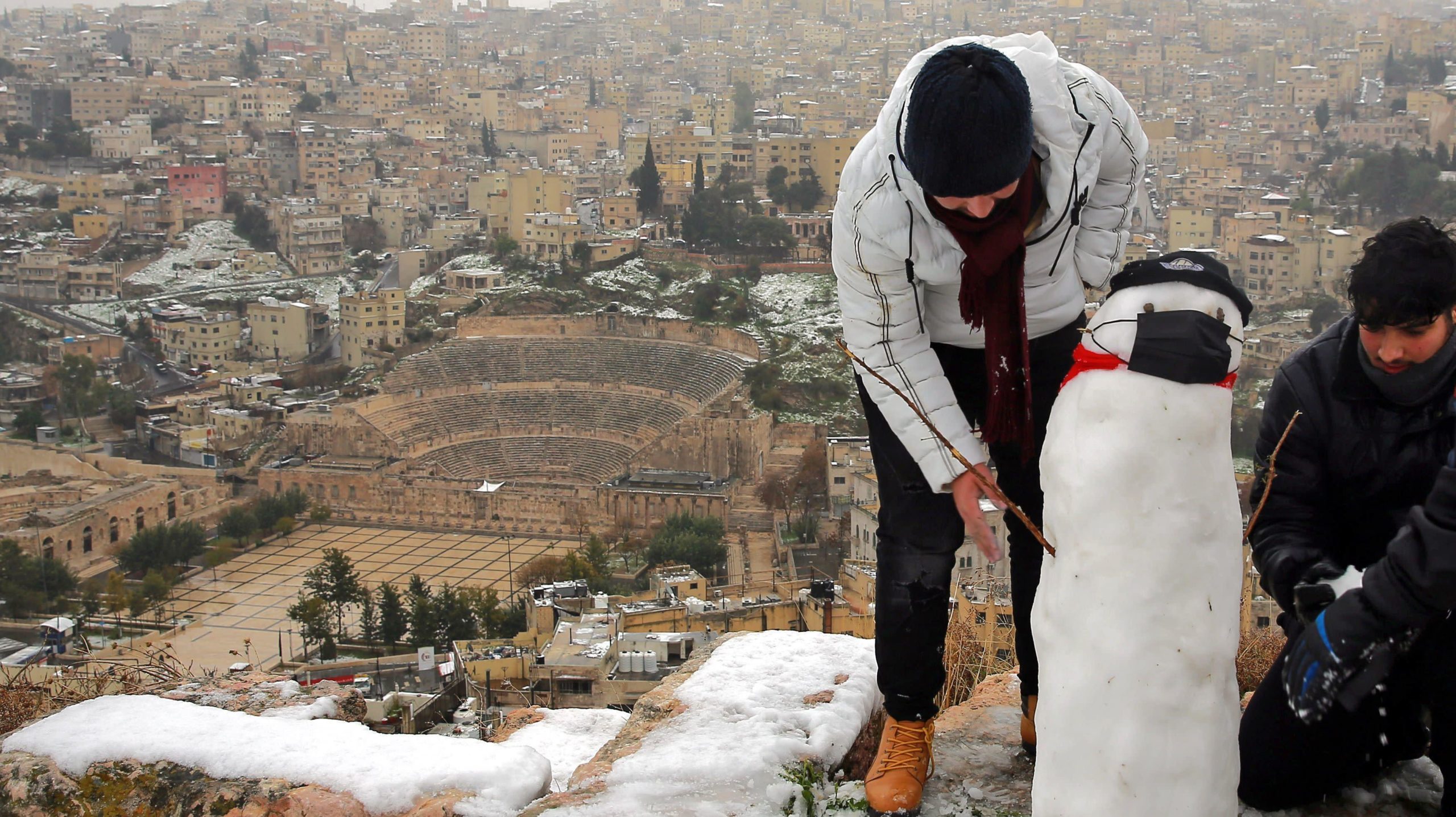 Jordanians make a snowman in the ruins of the Amman Citadel following a snowstorm in the Jordanian capital Amman, on Feb. 18, 2021. (Photo: Khalil Mazrawwi, Getty Images)