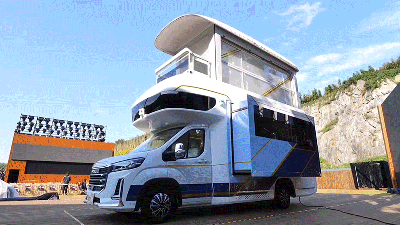 An Entire Second Floor Pops Out of this Tiny RV, Complete with a Working Elevator to Get Up There