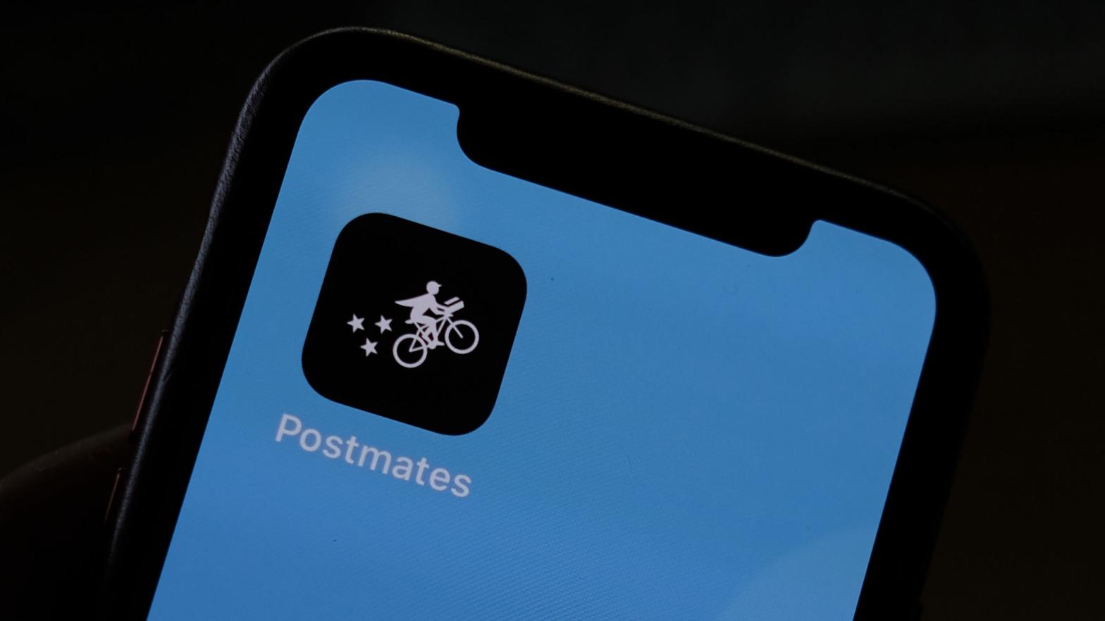 This illustration photo taken on June 30, 2020 shows the logo of delivery app Postmates on a smartphone screen in Los Angeles. (Photo: Chris Delmas / AFP), Getty Images)