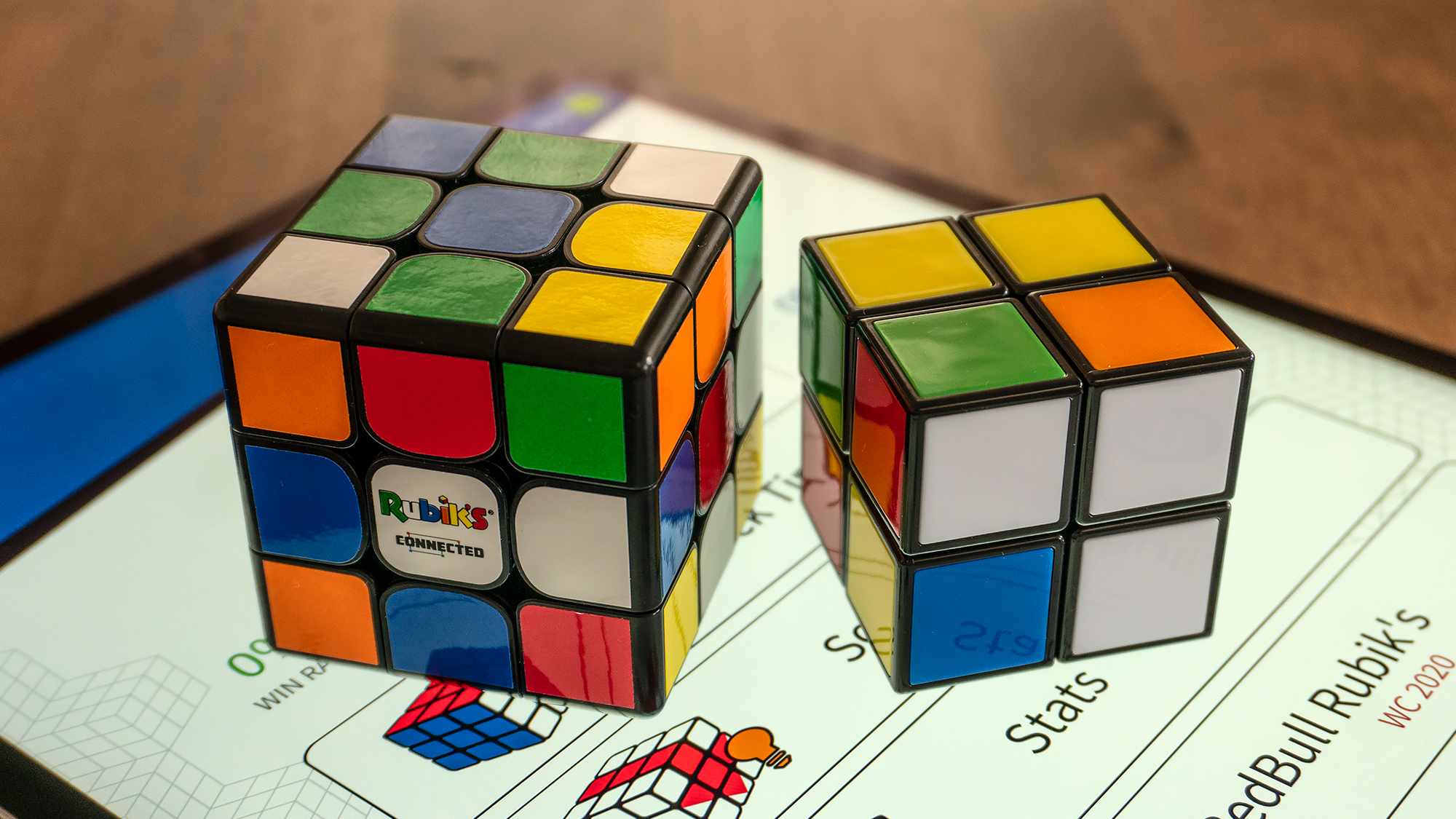 The Rubik's Connected Cube looks and feels like the original (here it's sitting next to a simpler 2x2 version of the puzzle) but features curved corners to facilitate Speedcubing. (Photo: Andrew Liszewski - Gizmodo)