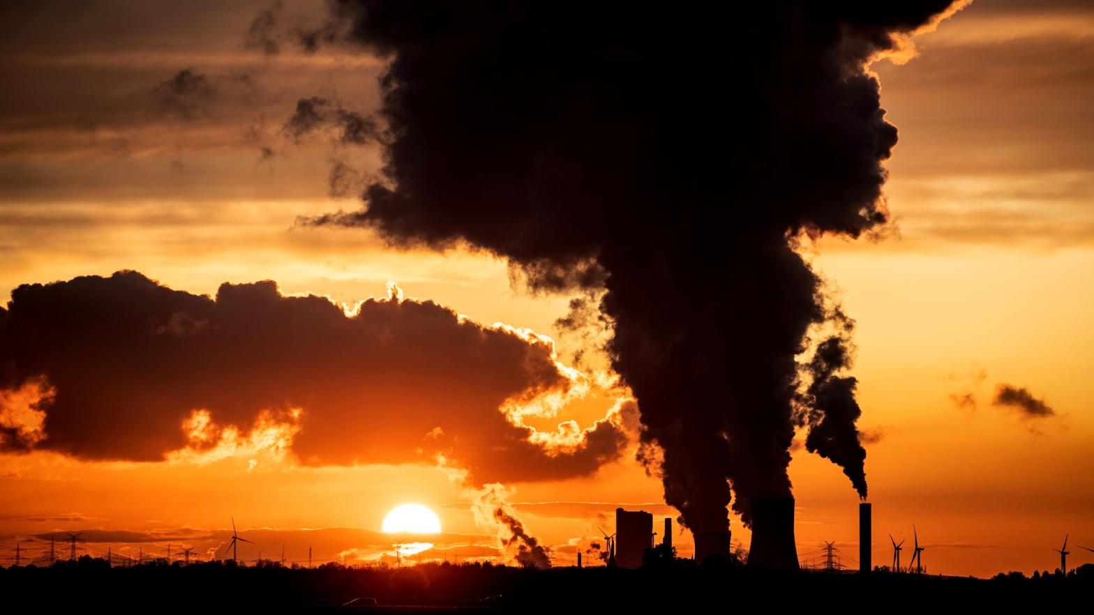 The sunset is pictured as steam rises from the chimneys of Niederaussen lignite-fired power plant in Roggendorf, western Germany on November 8, 2019. (Photo: Federico Gambarini / dpa / AFP, Getty Images)