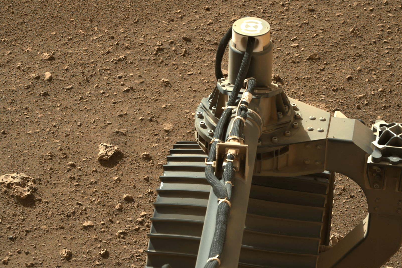 The rover's front left wheel and some rocks.  (Image: NASA/JPL-Caltech/ASU)