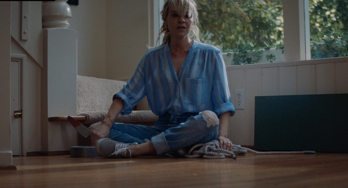 May (Brea Grant) faces yet another pool of blood in her home. (Image: Shudder)