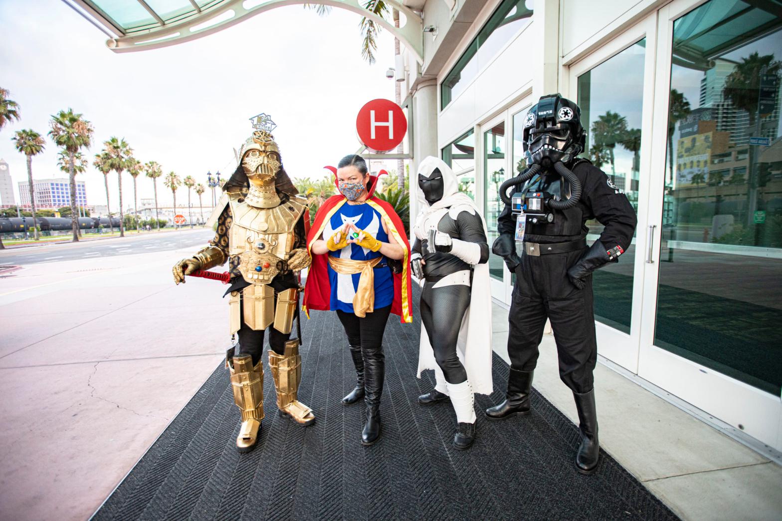 Cosplayers Christopher Canole as Dude Vader, Faeren Adams as Dr. Strange, Derek Shackelton as Moon Knight, and Todd Felton as a TIE pilot pose in front of Hall H at San Diego Convention Centre on July 22, 2020 in San Diego, California. (Photo: Daniel Knighton/Getty Images, iStock by Getty Images)