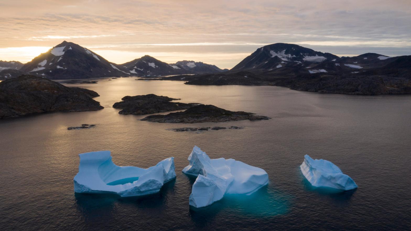 icebergs float away as the sun rises near Kulusuk, Greenland. (Photo: Felipe Dana, AP)