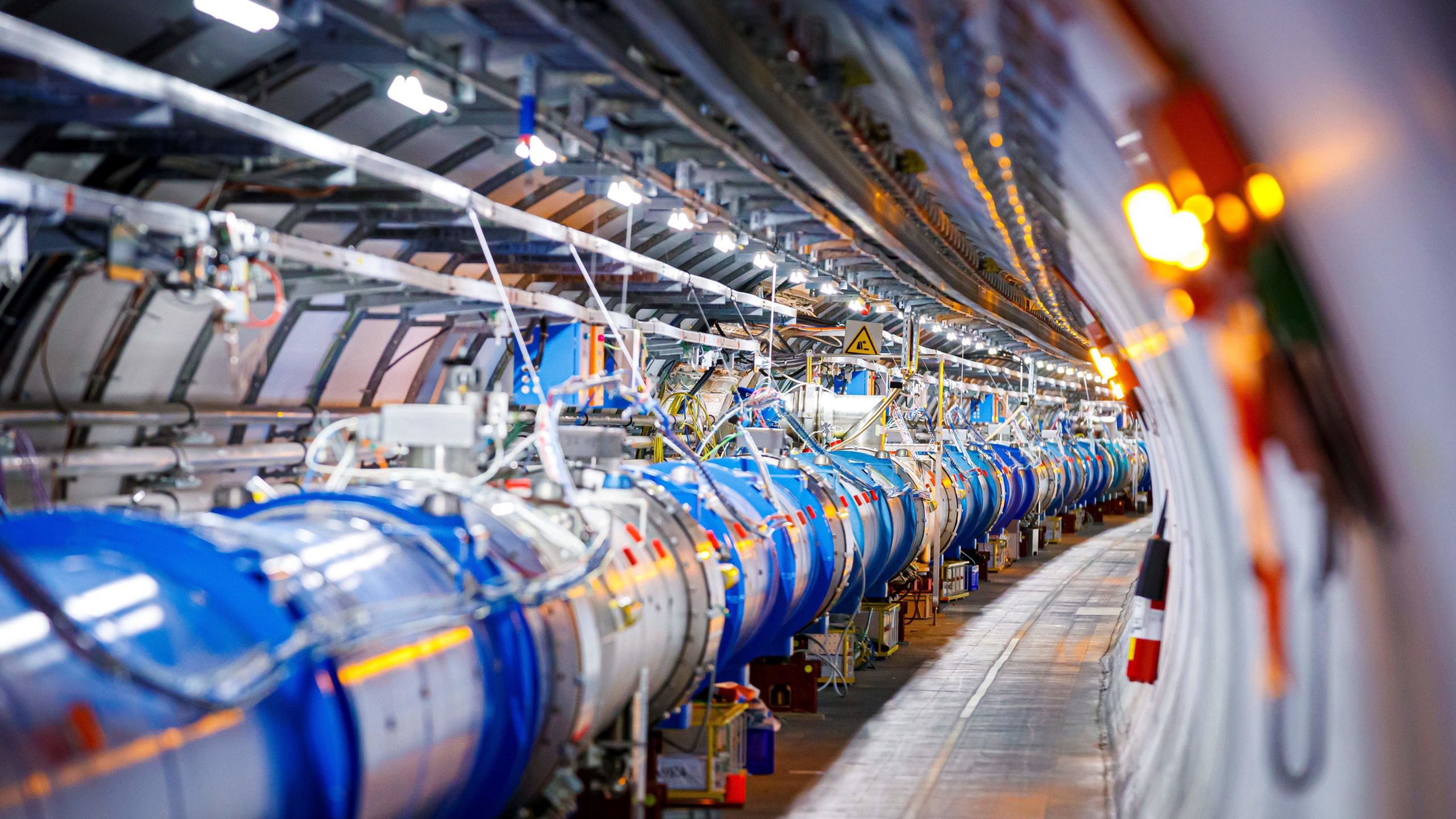 Some of the 1232 dipole magnets that bend the path of accelerated protons are pictured in the Large Hadron Collider (LHC) in a tunnel of the European Organisation for Nuclear Research (CERN), during maintenance work. (Photo: Valentin Flauraud / AFP, Getty Images)