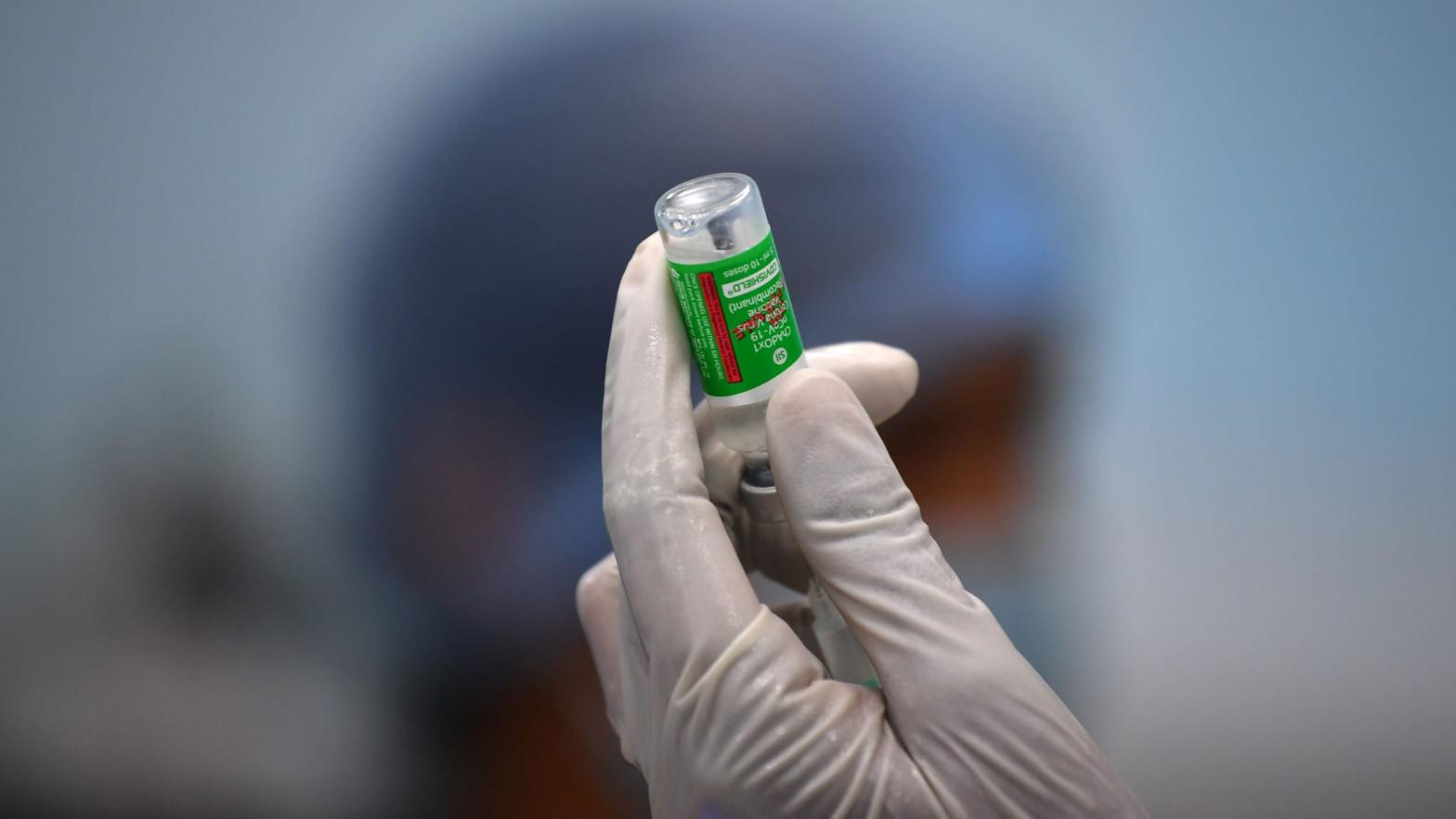 A staff member of the Rajawadi Hospital in India holds a vial of Covishield, AstraZeneca's Covid-19 coronavirus vaccine made by India's Serum Institute.  (Photo: Indranil Mukherjee, Getty Images)