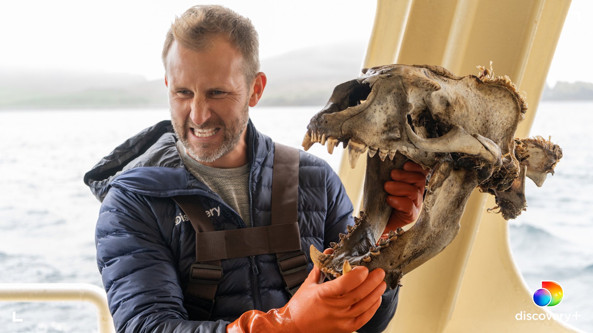 Ian Shive poses with a sea lion skull. (Photo: Ian Shive/discovery+)
