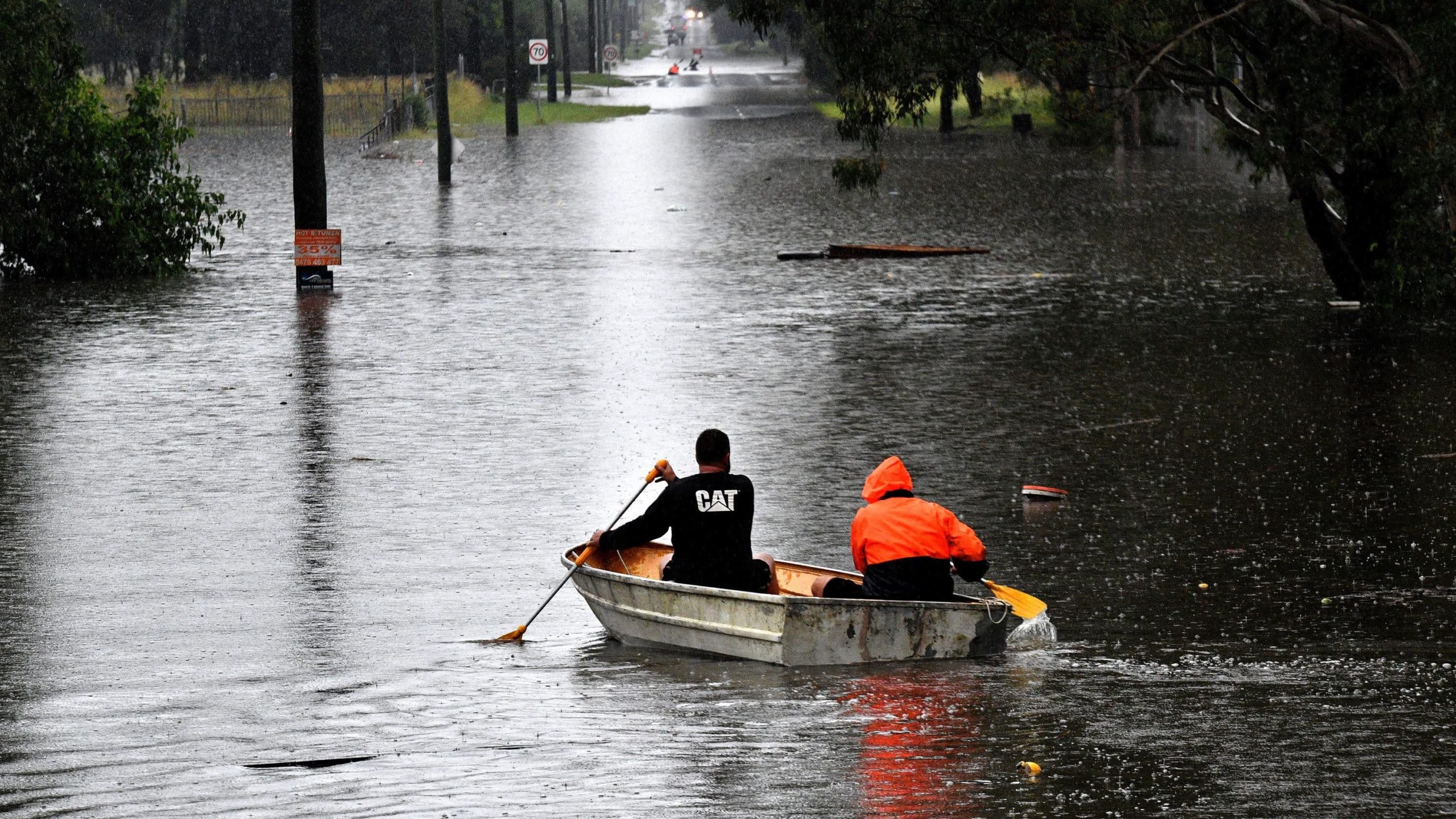 Residents commute on a boat in a flooded residential area near Windsor, Australia. (Photo: Saeed Khan/AFP, Getty Images)