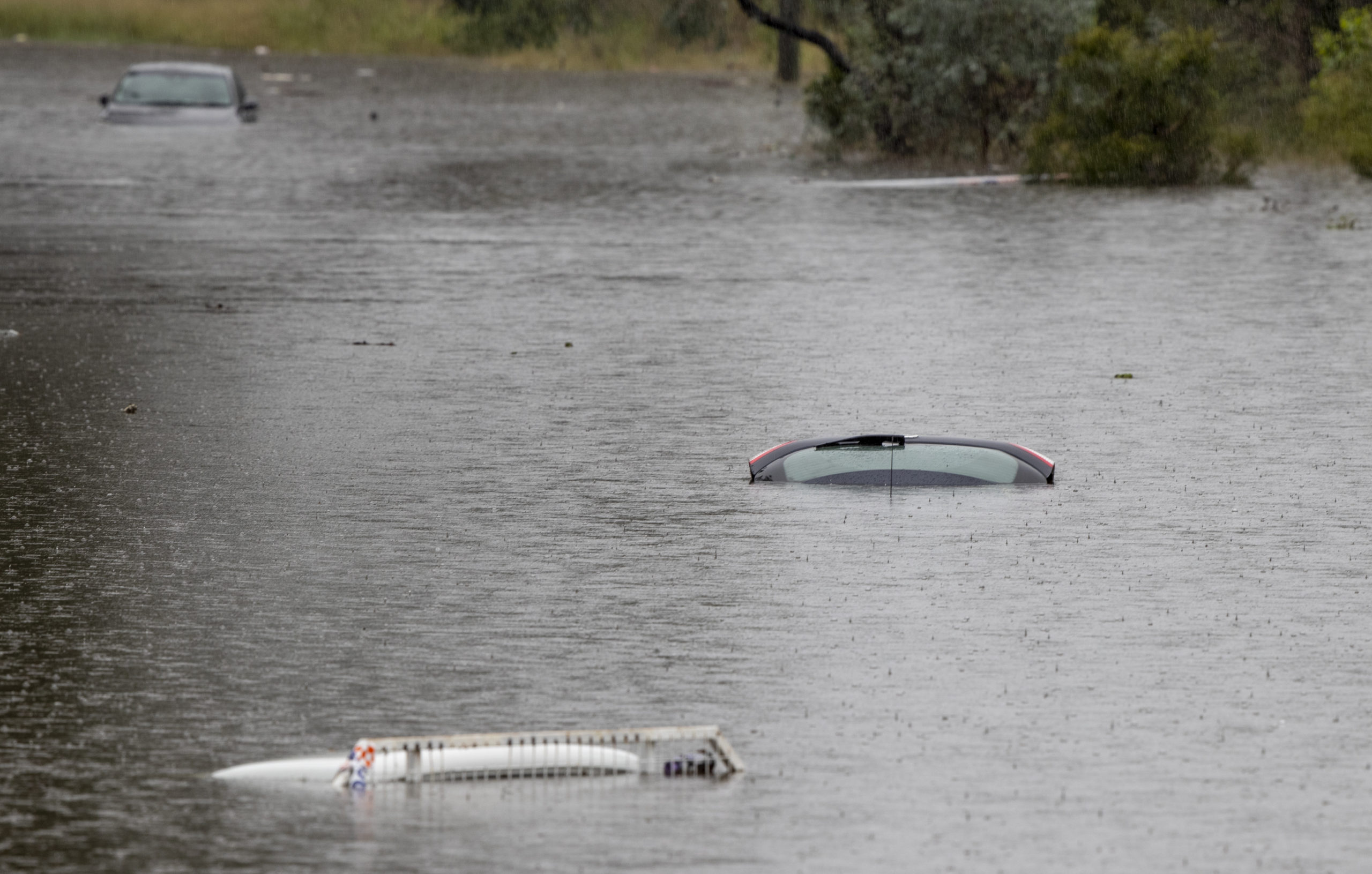 Vehicles are submerged in a flooded yard near Londonderry on the western outskirts of Sydney. (Photo: Mark Baker, AP)