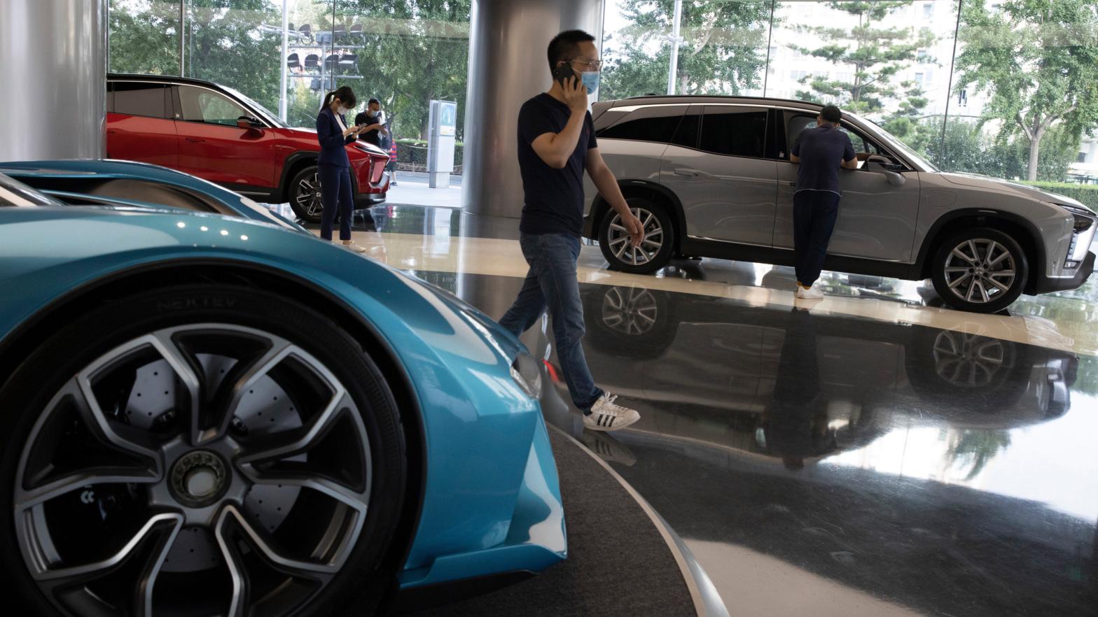 Visitors look at vehicles at the NIO flagship store in Beijing on Thursday, Aug. 20, 2020. (Photo: Ng Han Guan, AP)