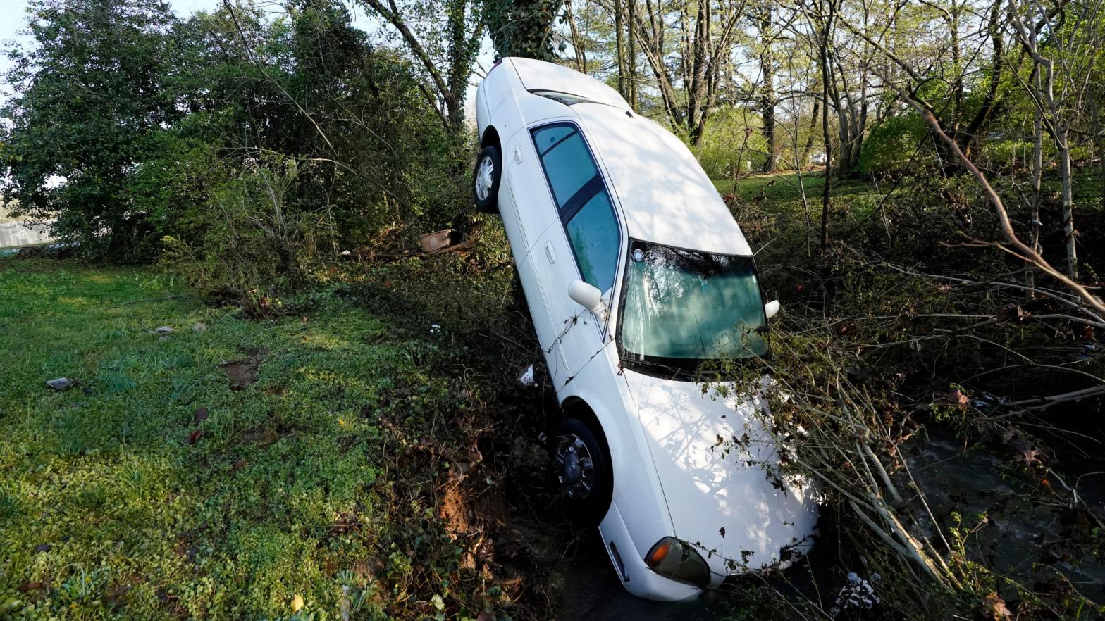 A car that was carried by floodwaters leans against a tree in a creek in Nashville. (Photo: Mark Humphrey, AP)