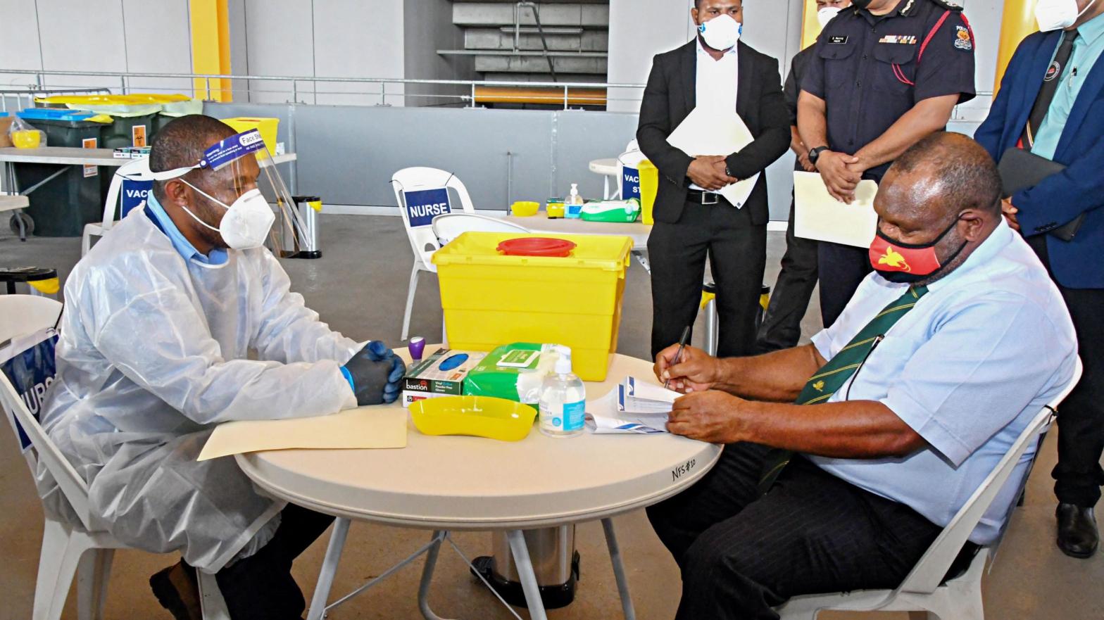 Papua New Guinea's Prime Minister James Marape (R) preparing to receive a dose of the AstraZeneca Covid-19 vaccine in Port Moresby on March 30, 2021. (Photo: Gorethy Kenneth/AFP, Getty Images)