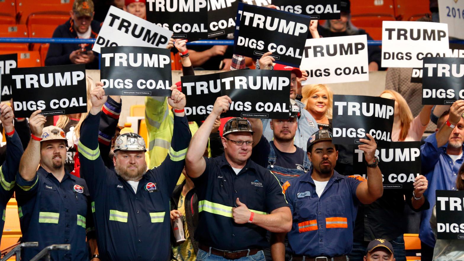 A group of coal miners wave signs for Donald Trump. (Photo: Steve Helber, AP)