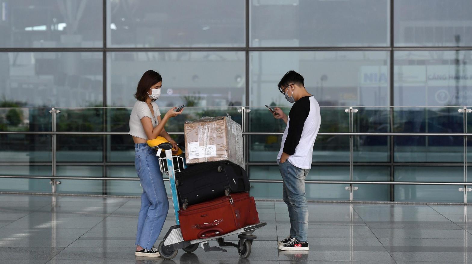 File photo of passengers standing outside the departure terminal at Noi Bai International Airport in Hanoi in 2020. (Photo: Nhac Nguyen/AFP, Getty Images)