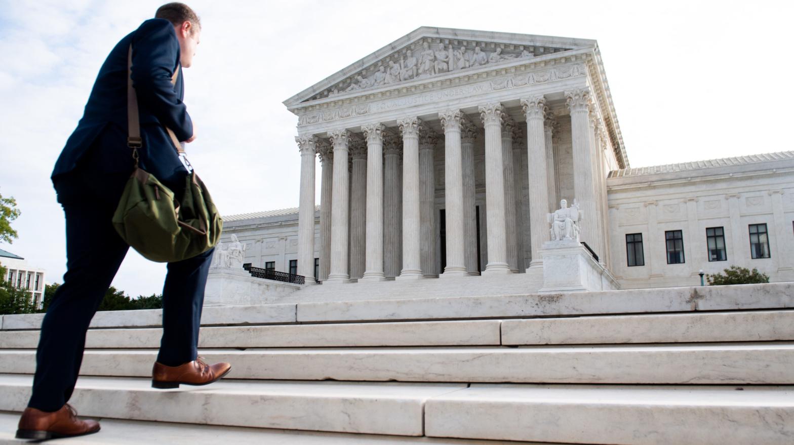 A man walks up the steps on the first day of a new term at the US Supreme Court in Washington, DC, October 7, 2019 (Photo: SAUL LOEB / AFP, Getty Images)