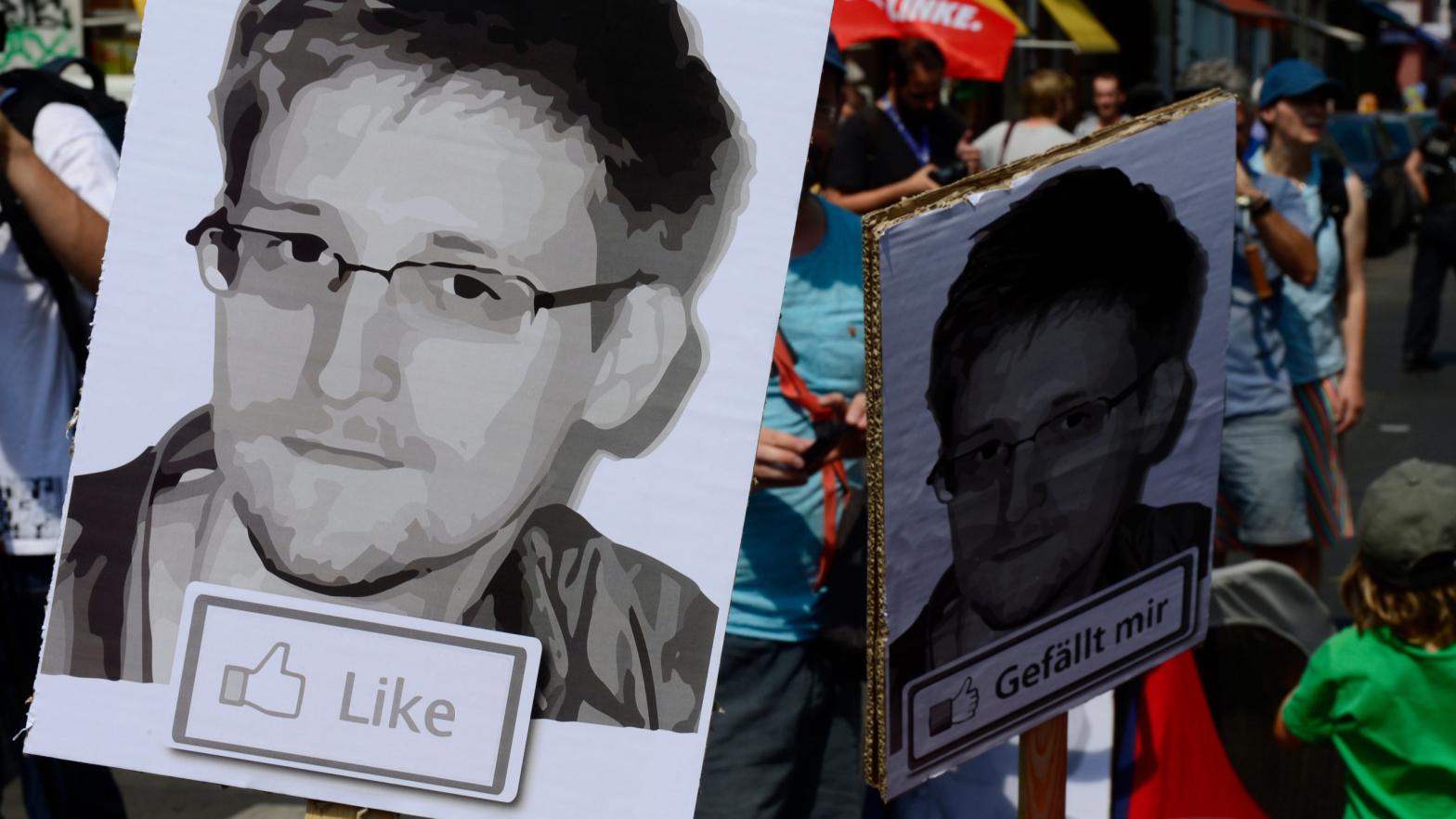 Demonstrators hold placards featuring an image of former U.S. intelligence contractor Edward Snowden as they take part in a protest the NSA's surveillance in Germany on July 27, 2013.  (Photo: John Macdougall/AFP, Getty Images)