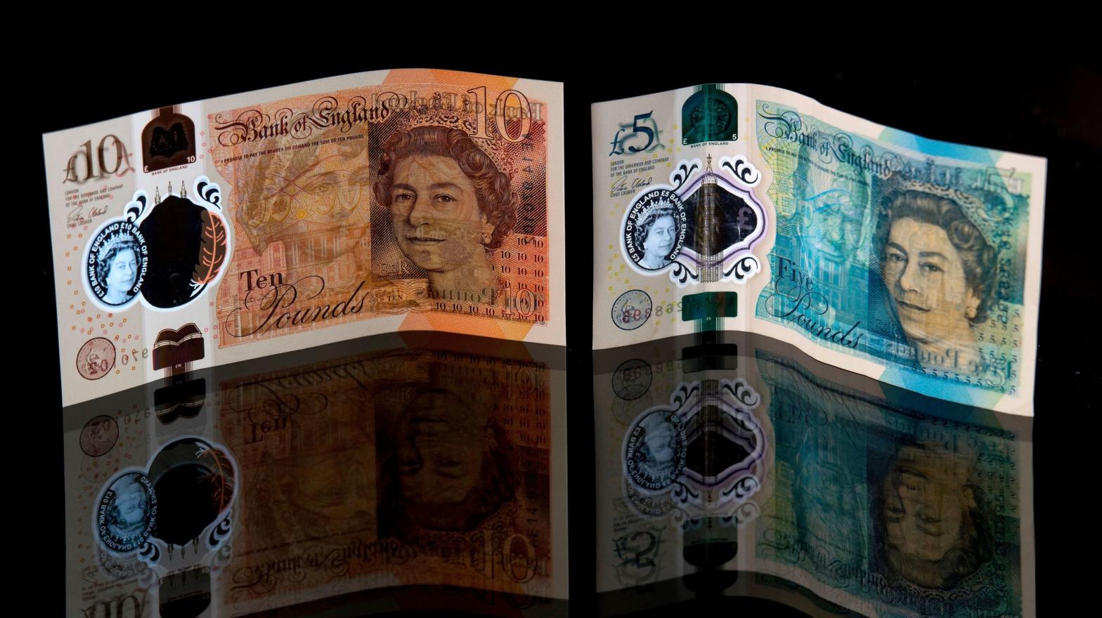 A British ten pound sterling and five pound sterling note are arranged in a photograph in London. (Photo: Justin Tallis, Getty Images)