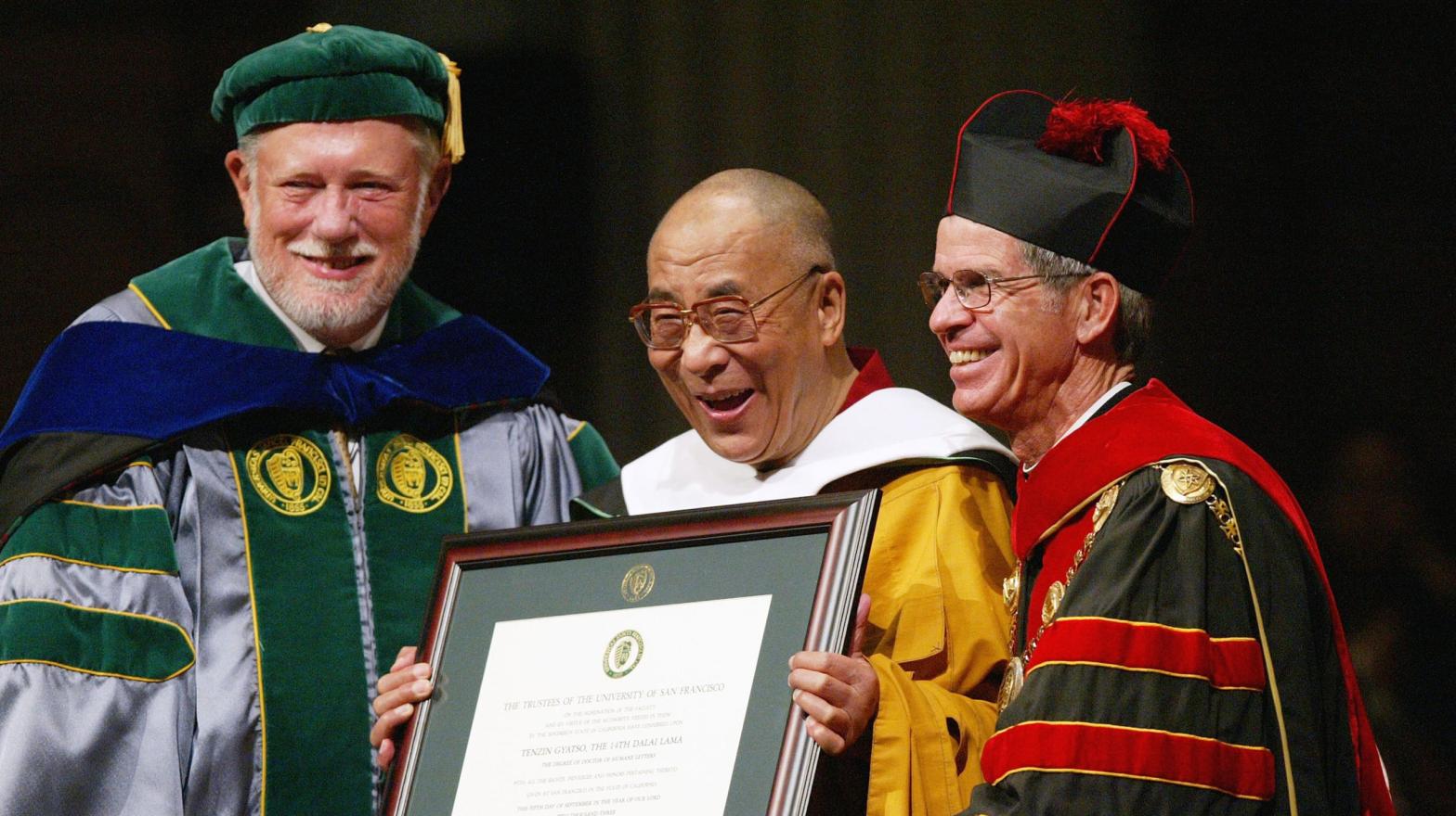 Adobe co-founder and University of San Francisco chairman Charles Geschke (left) presents an honorary degree to the Dalai Lama alongside USF president Steven Privett (right) in San Francisco, California in 2003.  (Photo: Justin Sullivan, Getty Images)