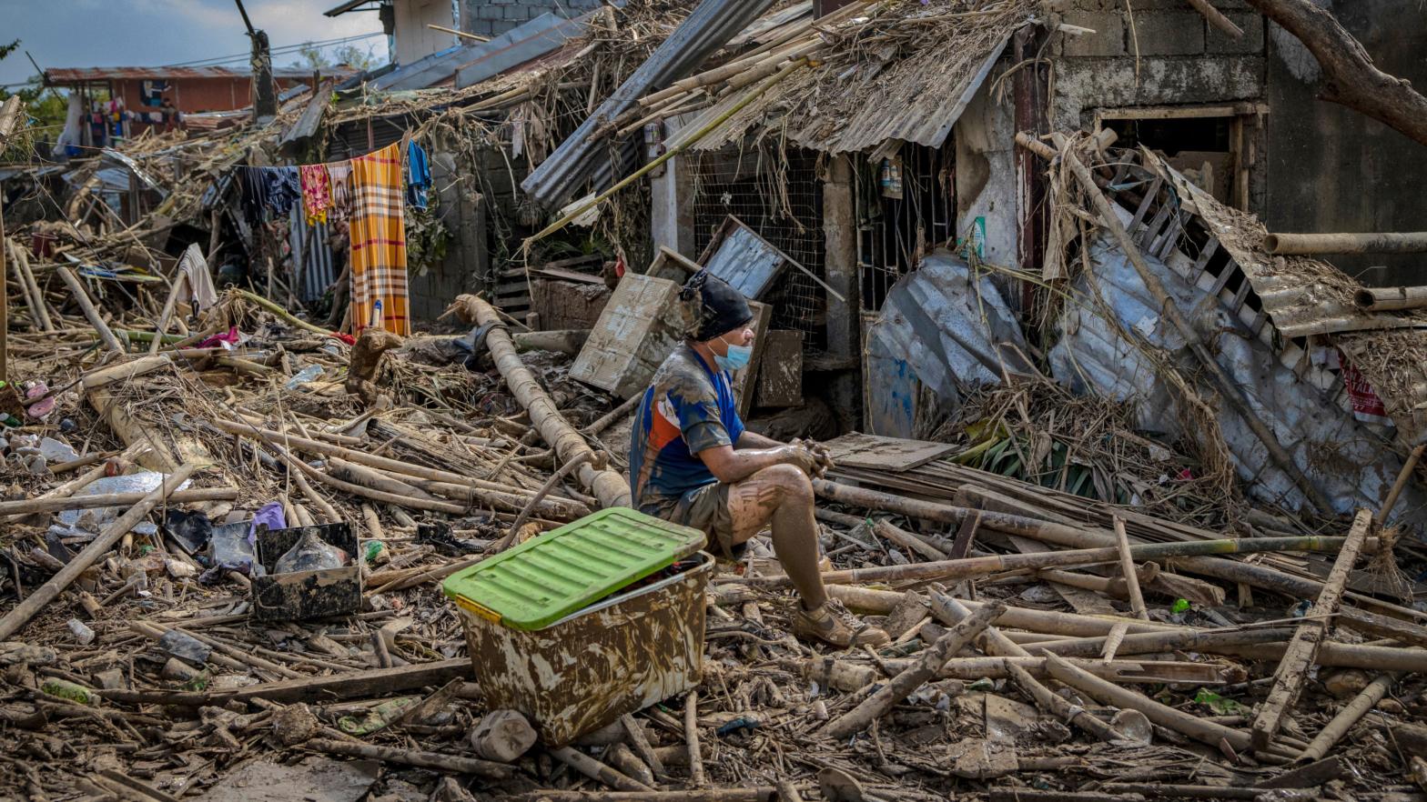 A resident sits outside destroyed houses after Typhoon Vamco hit on Nov. 14, 2020 in Rodriguez, Philippines. (Photo: Ezra Acayan, Getty Images)